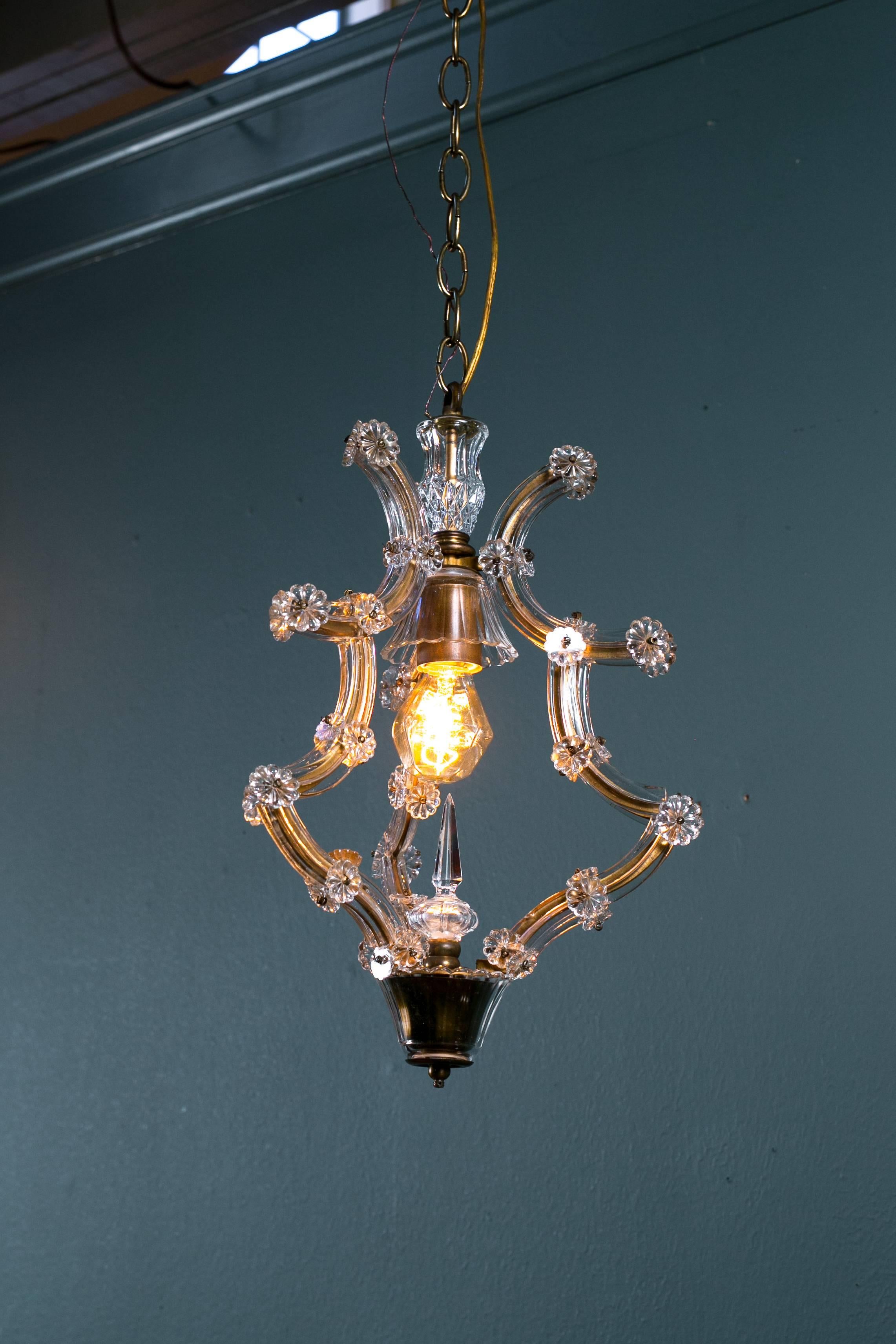 Matching pair of vintage French pendants in the Maria Theresa style. Glass pieces and rosettes over a gilt brass cage. Newly wired in the USA with all UL approved parts and a single Edison socket. Comes with matching chain and canopies.