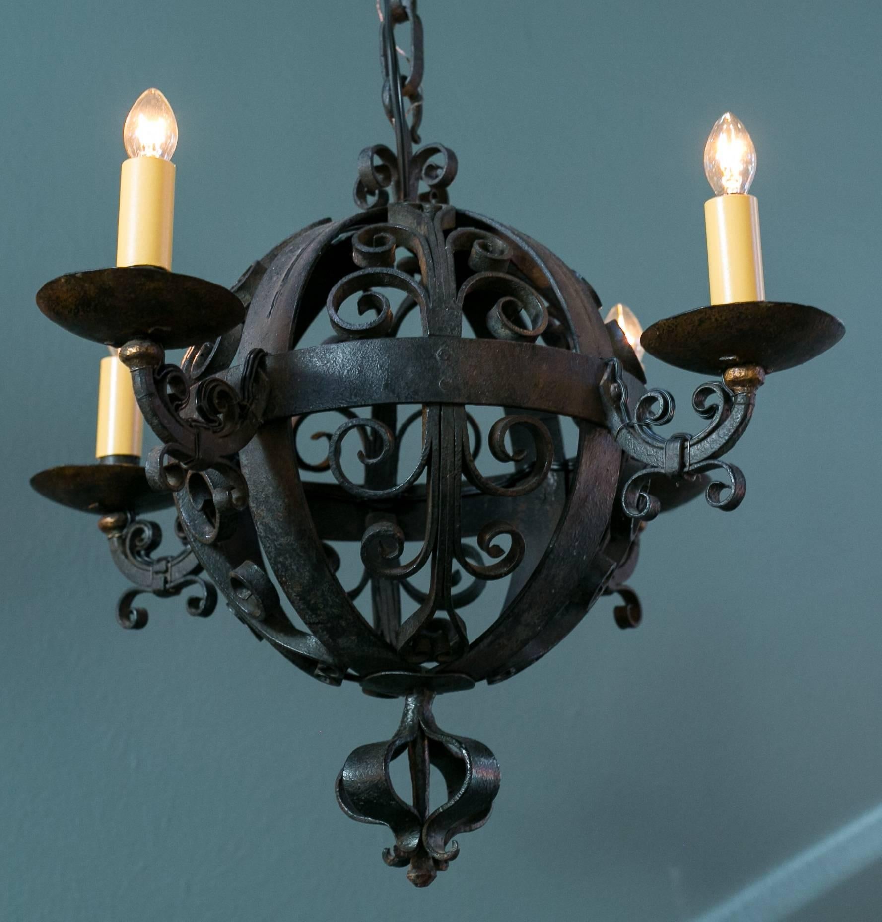 Hand-wrought, Spanish Colonial style iron sphere lights with gold accents, newly rewired in the USA with all UL listed parts and four candelabra sockets. From Spain, circa 1960. Petite in size.  Perfect for an Addison Mizner house. Comes with