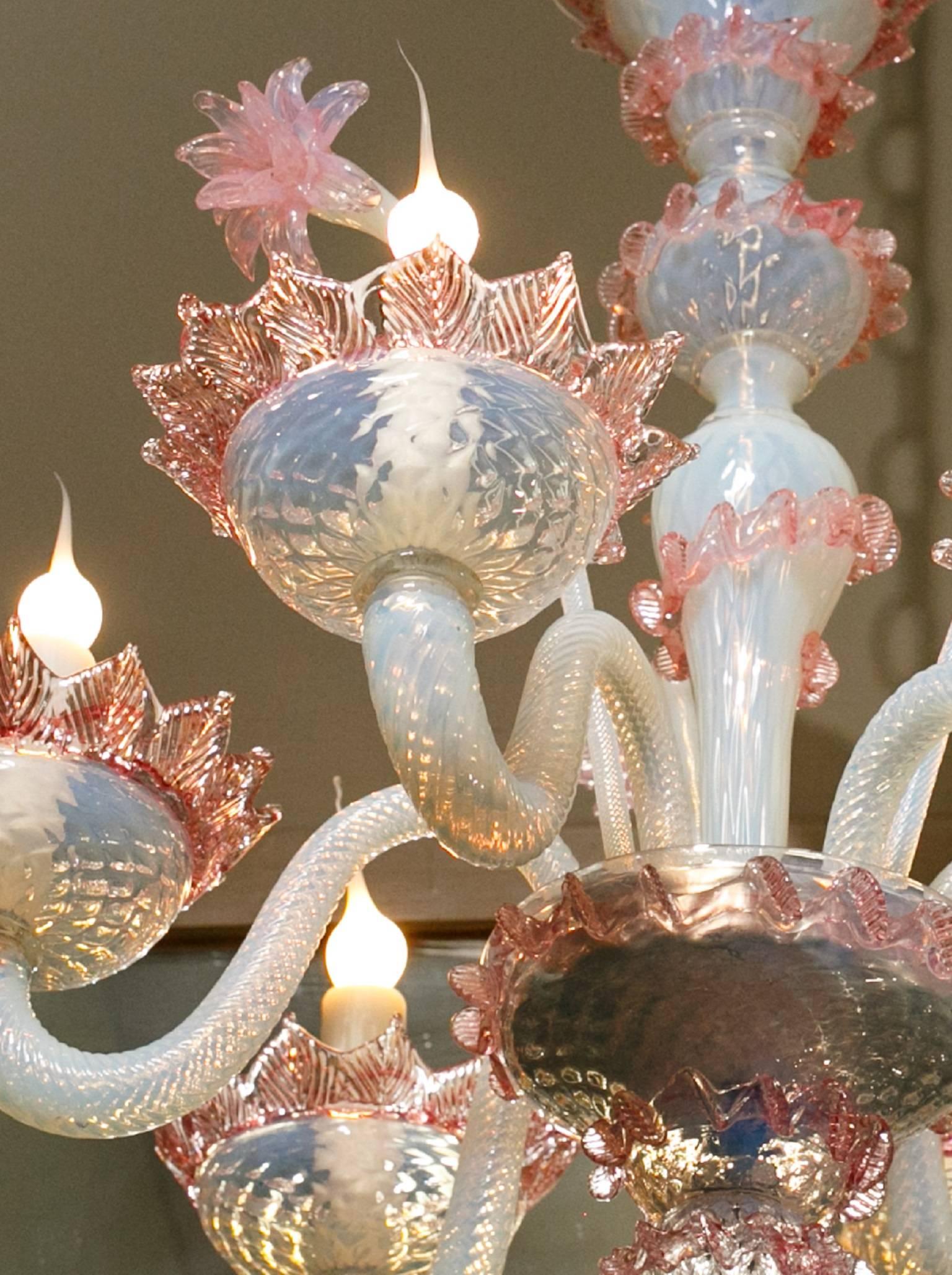 Handblown Classic pink and white Murano glass chandelier from Italy, circa 1940. Newly rewired with UL listed parts and six candelabra sockets. Features three handblown pink glass flowers on stems. Comes with silver colored chain and canopy.