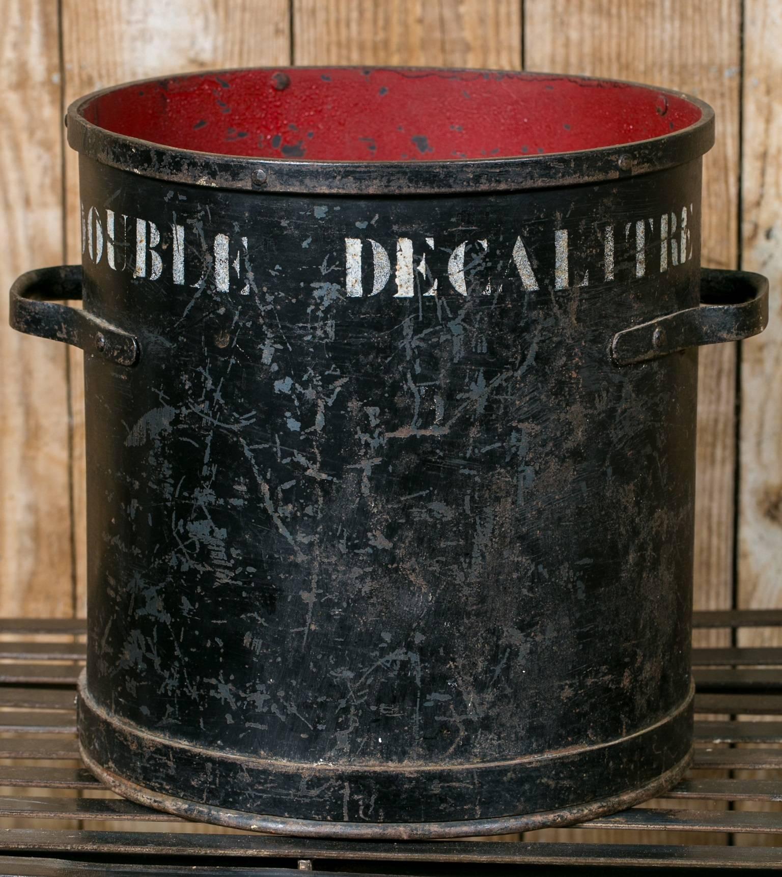 Wonderful old Belgian measure with two handles. All original with black paint on the outside, red paint on the inside and white stencilling on across the top labelling it as a double decalitre size. Handcrafted and painted. Great size for a waste