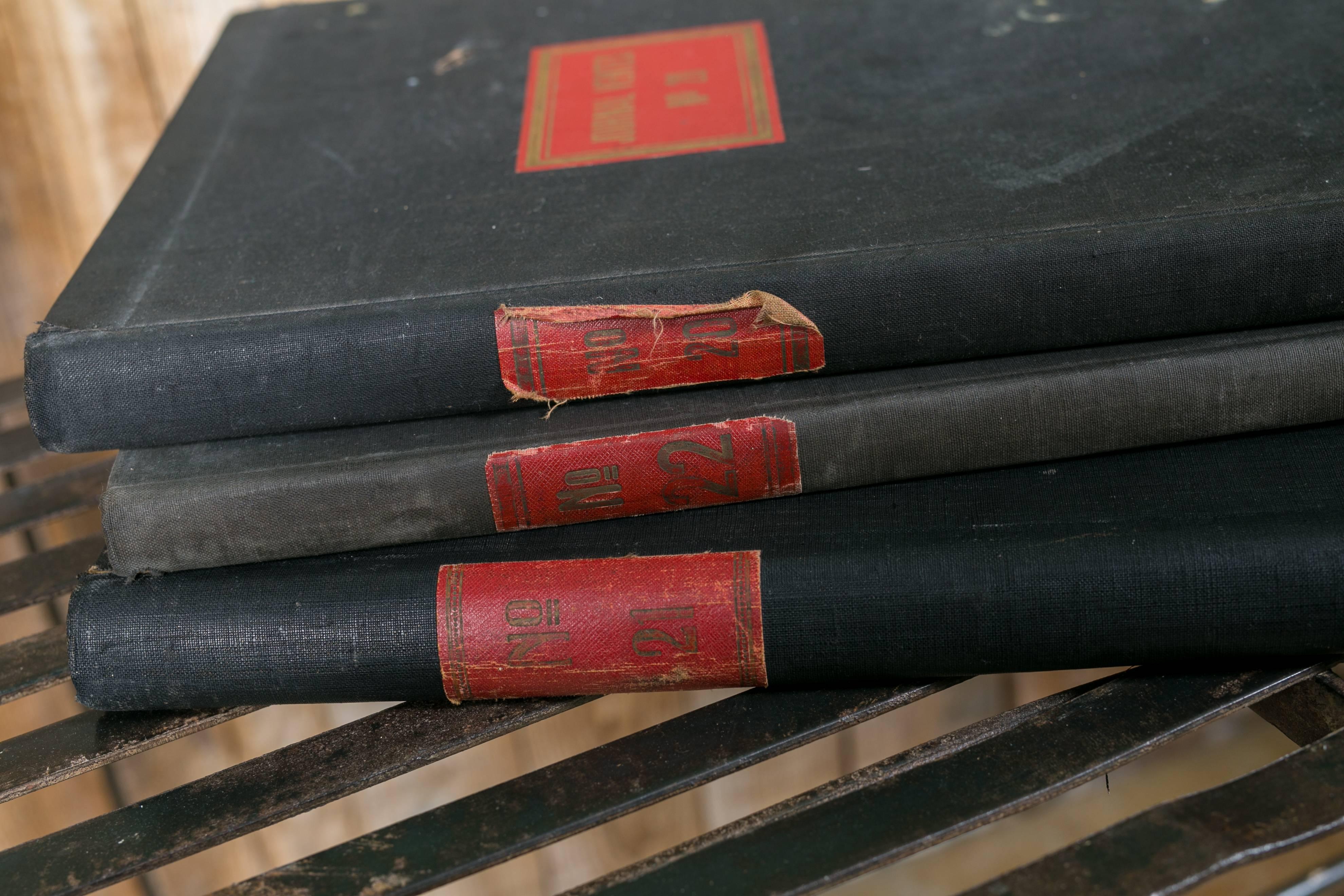 Collection of vintage Belgian fabric covered bound accounting books. Black rigid covers with red labels on the spine and front. Gilt lettering on some of the titles. Lined paper inside with vintage accounts written on the pages. Price is for three.