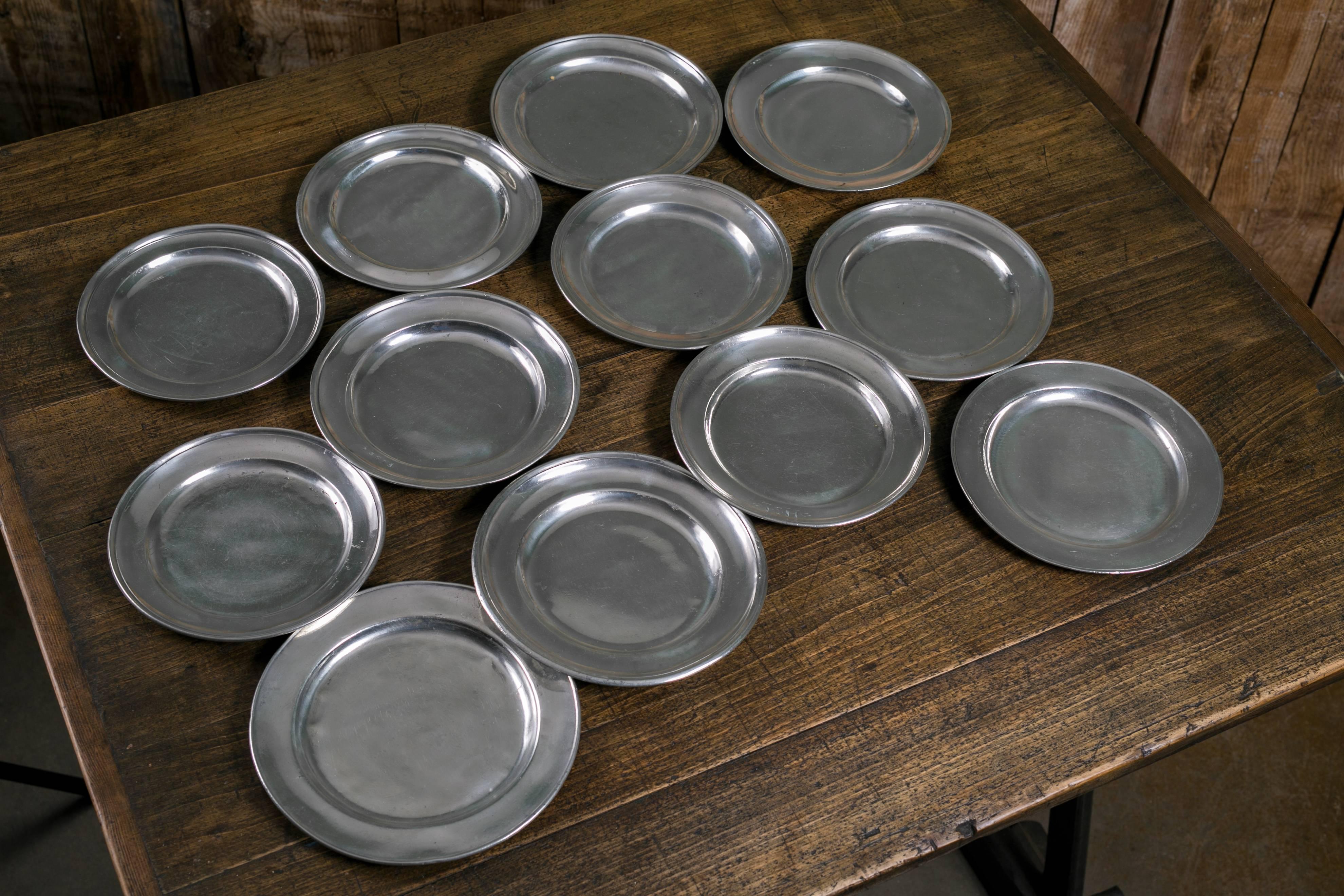 Assorted collection of 12 vintage pewter plates from Belgium. Beautiful light silver coloring. Some are stamped. Lovely as a wall or hutch display. Price is for the set of 12 plates. Sizes vary slightly.