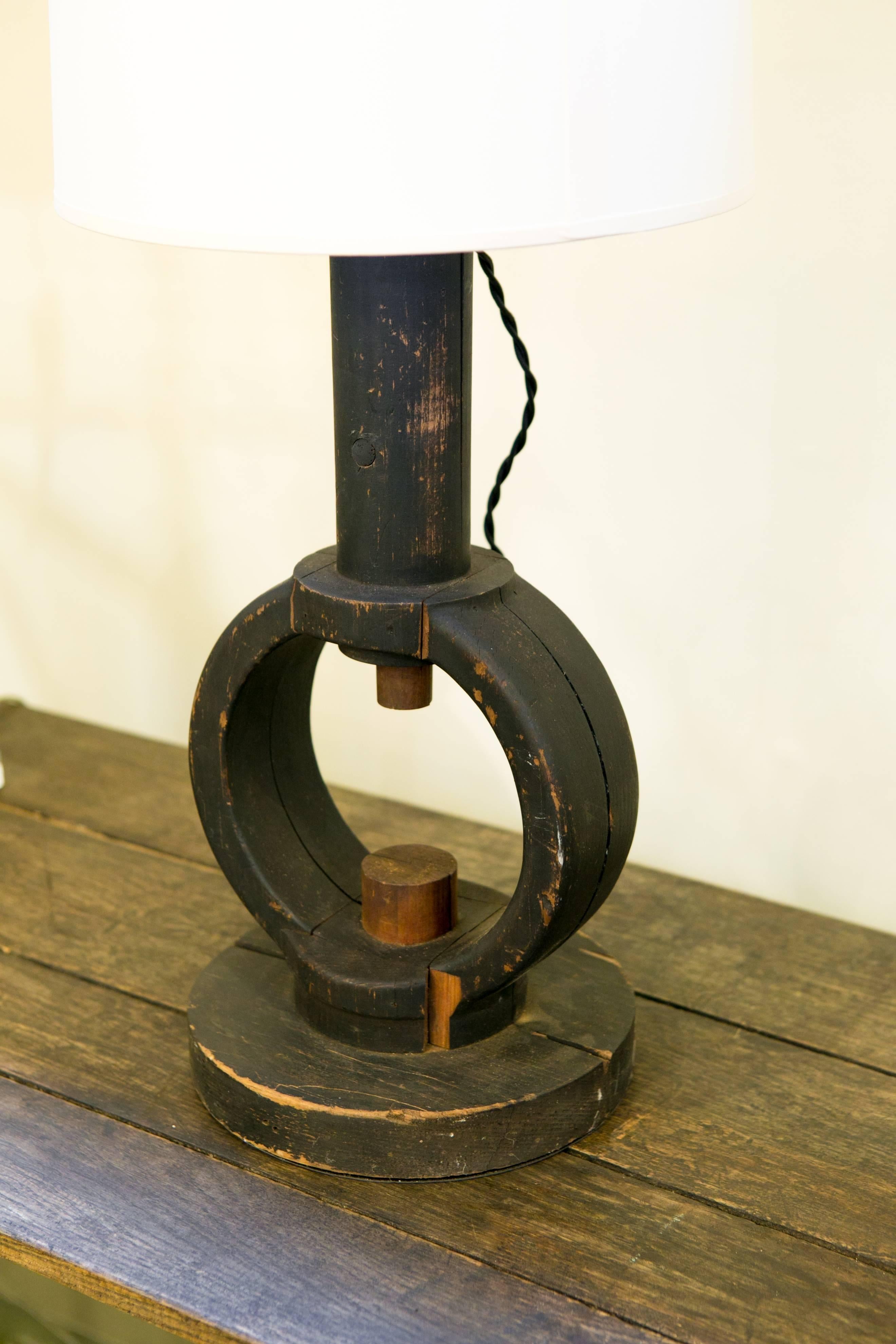 Unusual, one of a kind, handcrafted painted black wood table lamp from Belgium. Made from antique parts, newly wired with all UL listed components and a black fabric twisted cord. Harp and saddle configuration with a single Edison based socket. Sold