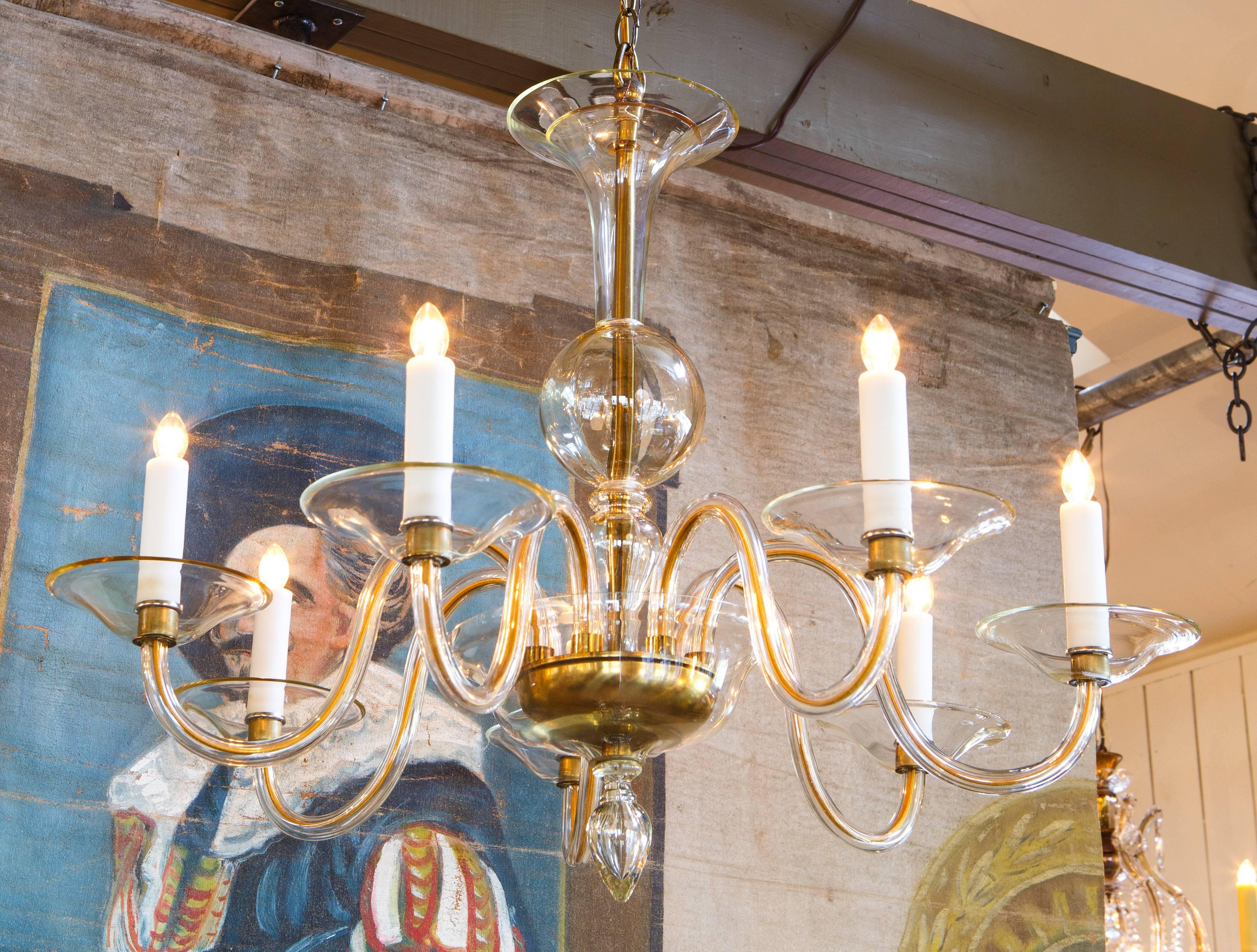 Pair of champagne colored blown glass chandeliers from Murano, Italy. Beautiful shape and proportion with centre ball in the post and blown glass finial at the base. Newly wired with all UL listed parts and seven candelabra sockets per fixture.