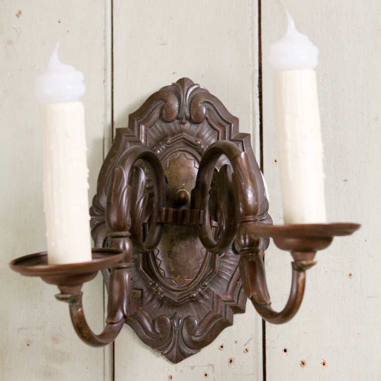 Heavy bronze sconces with two arms from Belgium, circa 1910. Beautiful patina and design. Newly re-wired in the US with all UL approved parts and two Edison sockets. Some refer to this classic style as Dutch Baroque or also Flemish.
These have