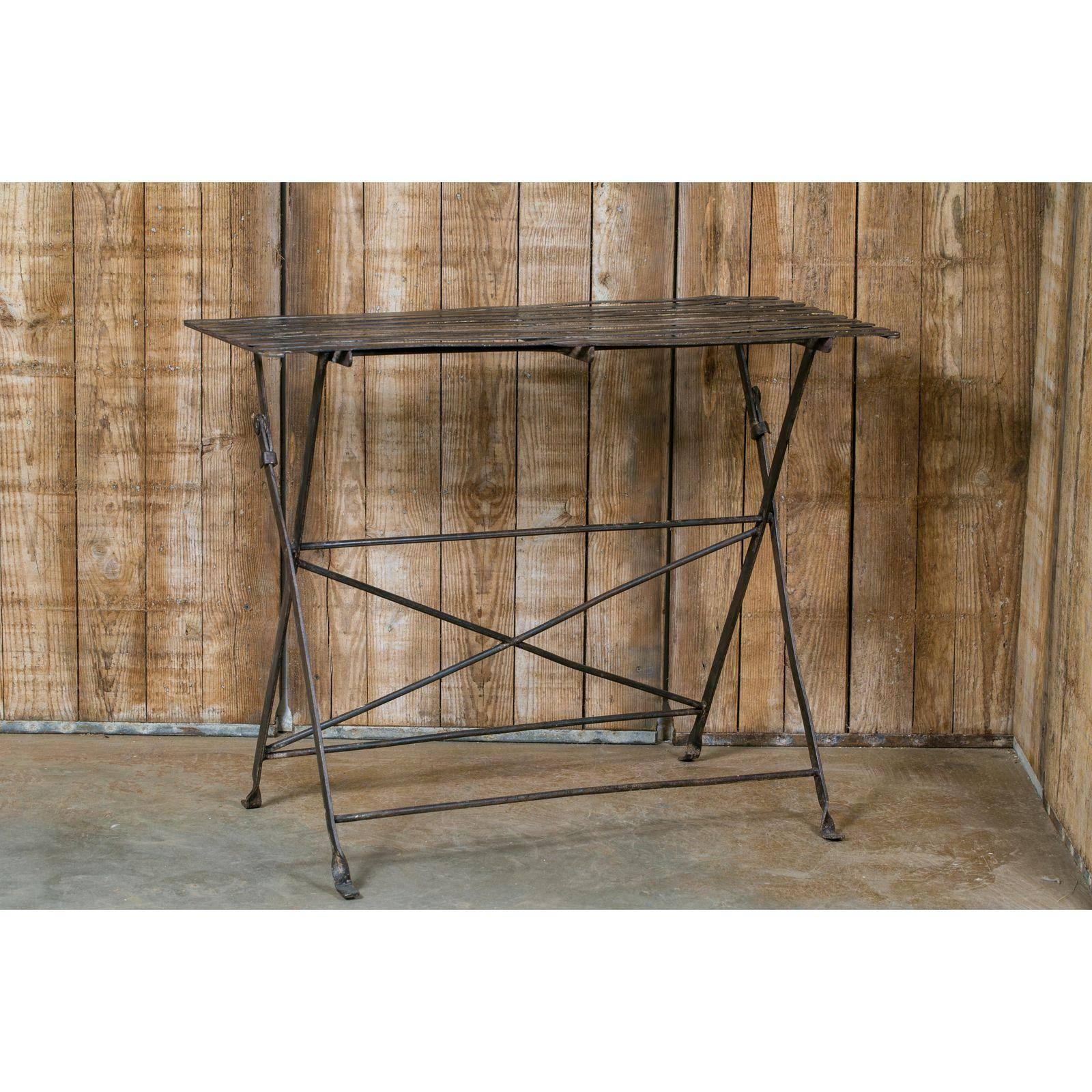 Long iron rectangular table with a metal slat top. Folds up for compact storage. From France, circa 1920.