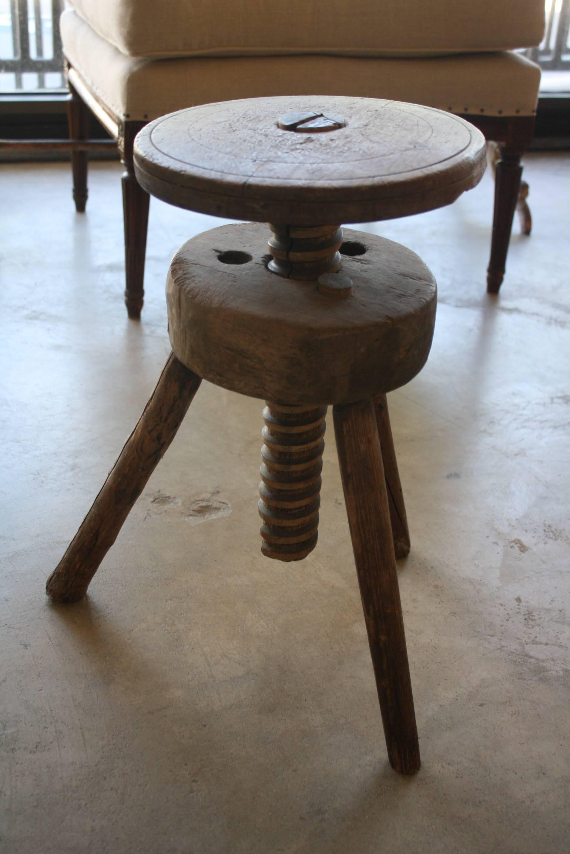 Vintage adjustable artist's stool with carved wood screw post.