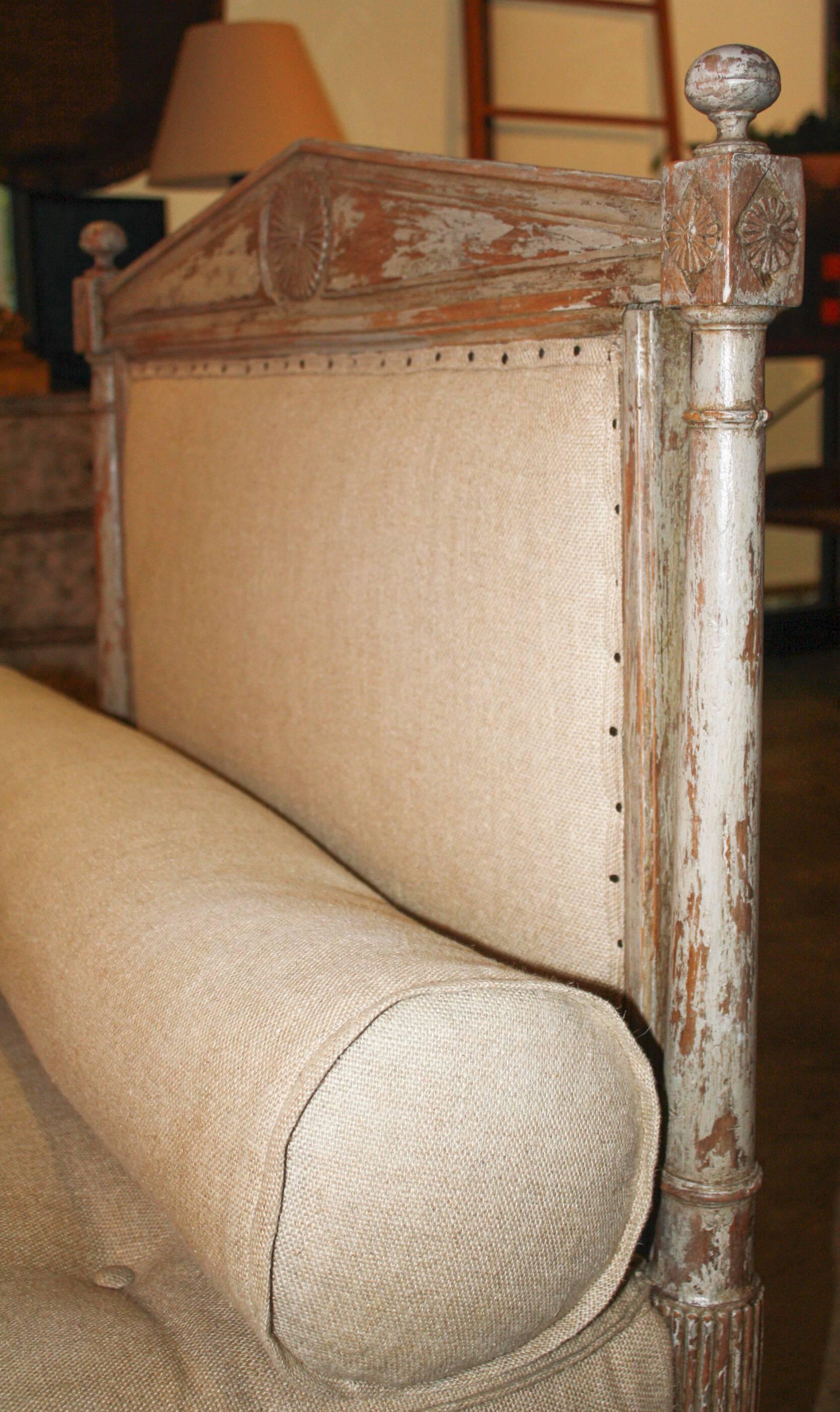 19th century French daybed in scraped finish, newly upholstered.