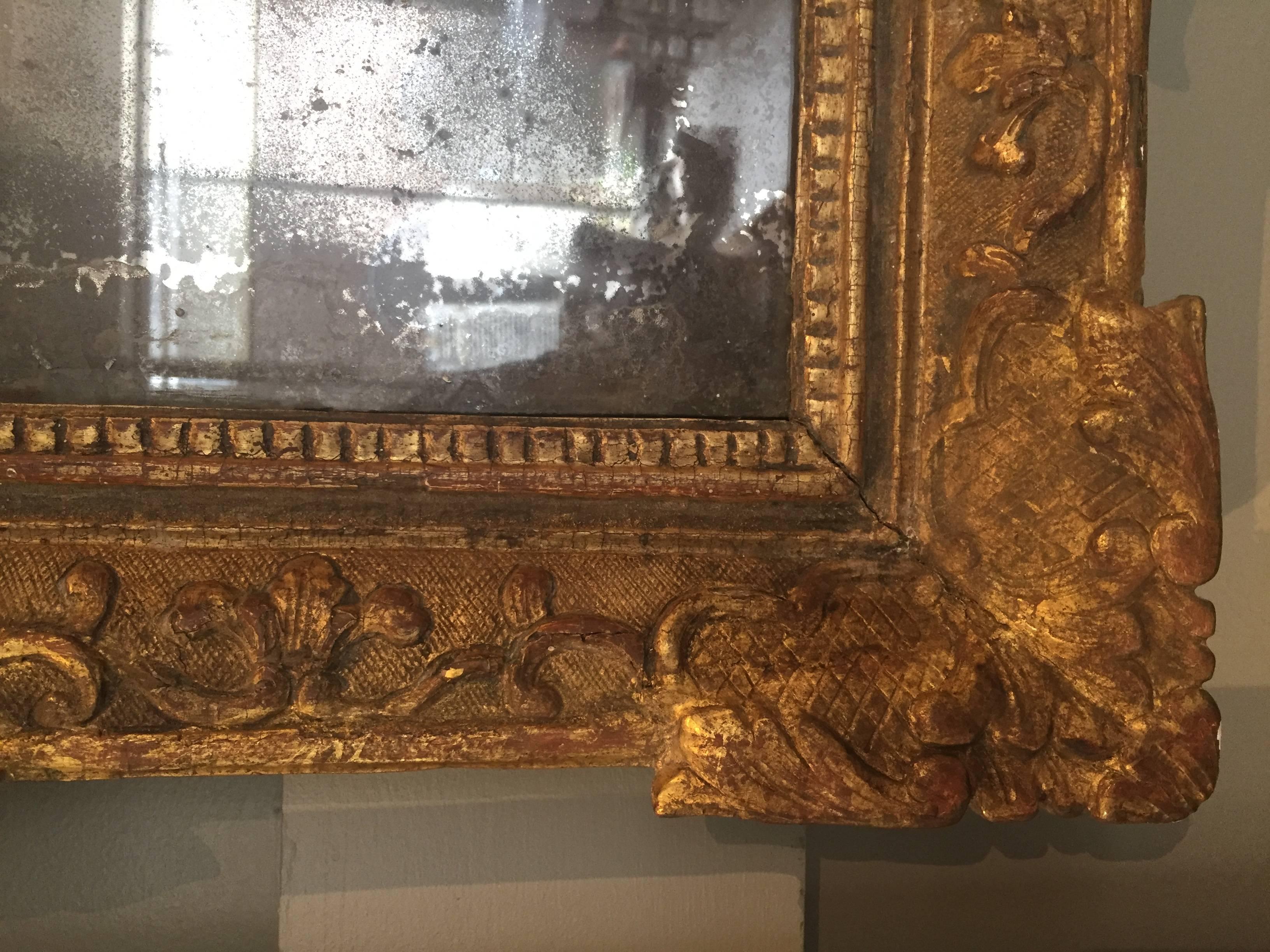 Louis XIV gilt mirror with original mercury mirror, quiver motif, circa 1700.
Dimension: 24.5" W x 2" D x 45" H.