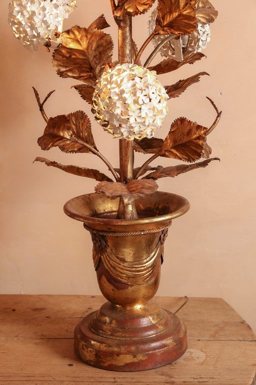 Italian gilded tole floor lamp with painted hydrangeas. Urn is decorated with a swag design. Seven lights. Has been wired for the USA.