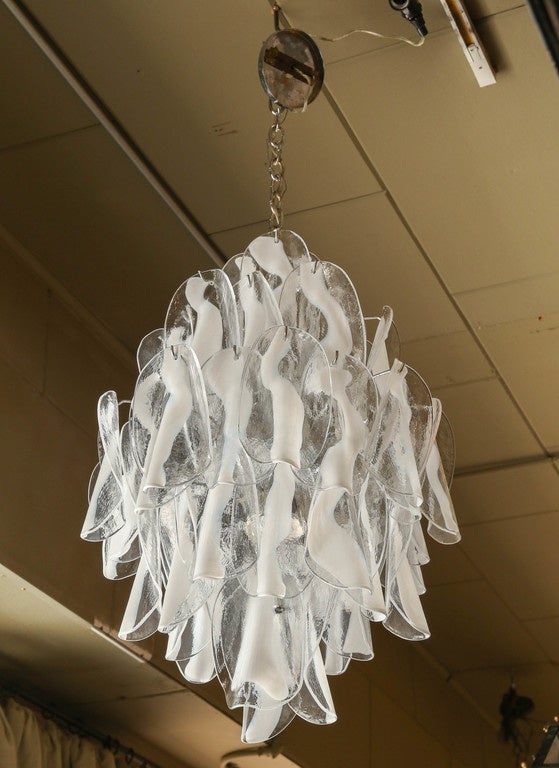 Mid-Century chandelier attributed to Barovier e Toso. The fixture is made up of thirty six individual handblown glass elements hanging from a chrome frame. Each piece clear with white centre.