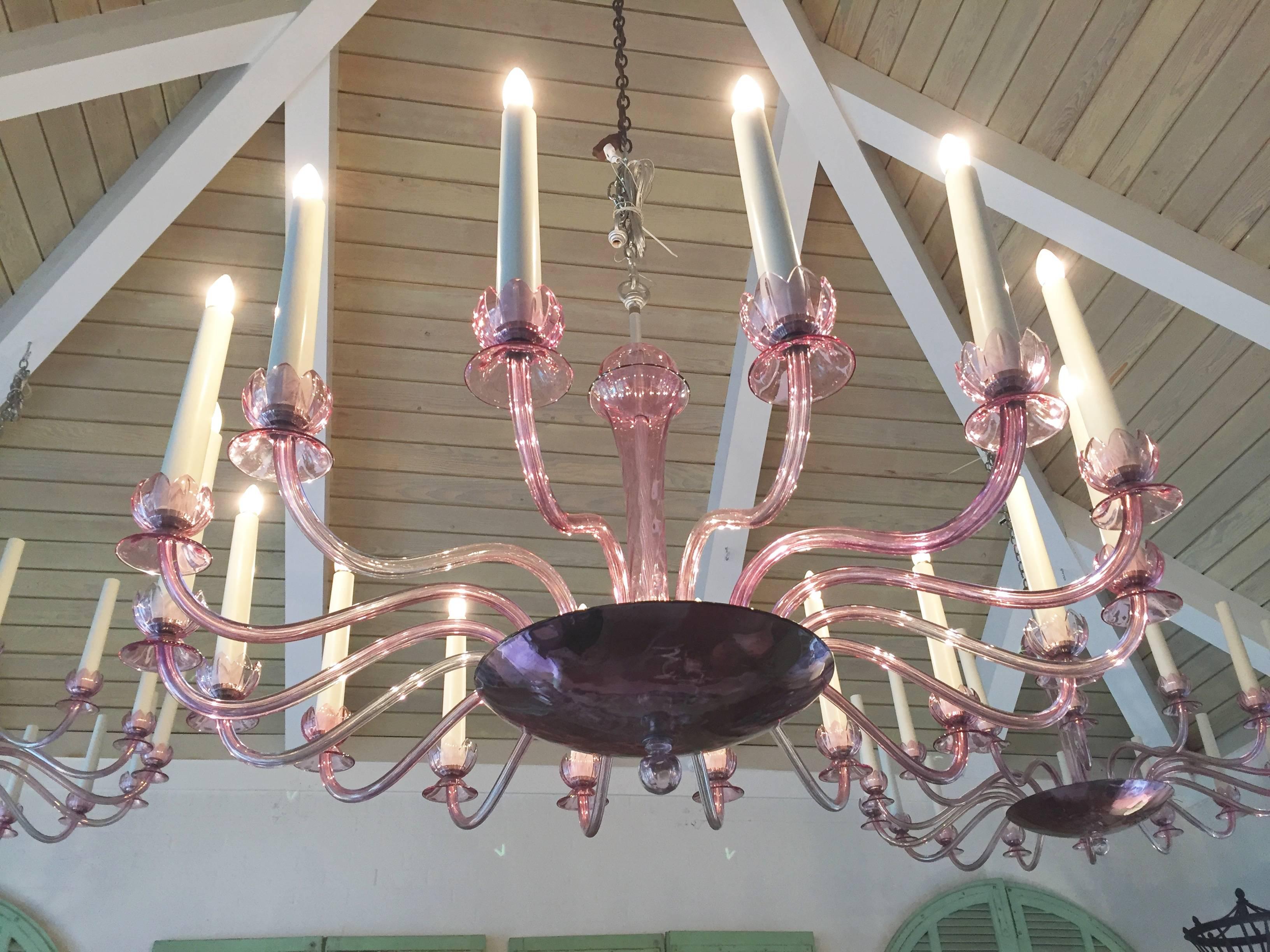 Handsome and large 1930s Murano Chandeliers in an Amethyest color glass. Perfect original condition, original tole candles and just cleaned and re-wired. Edison base bulbs. Two available. Original chrome canopys. Also two pairs of matching five-arm