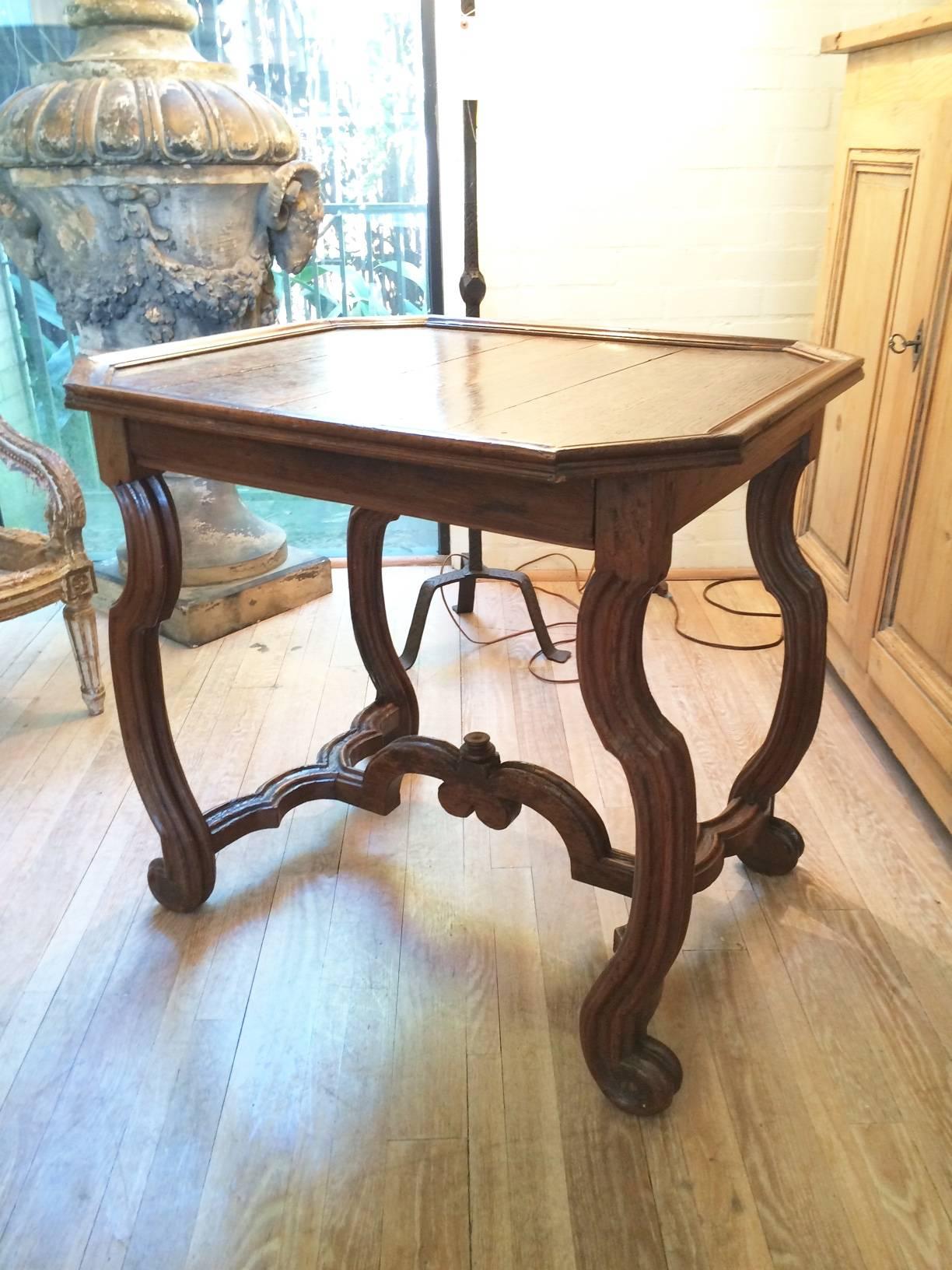 Handsome Louis XIV bold oak and walnut table with bold walnut curving and carved legs and stretchers and an oak tray top. Hidden drawer under top.