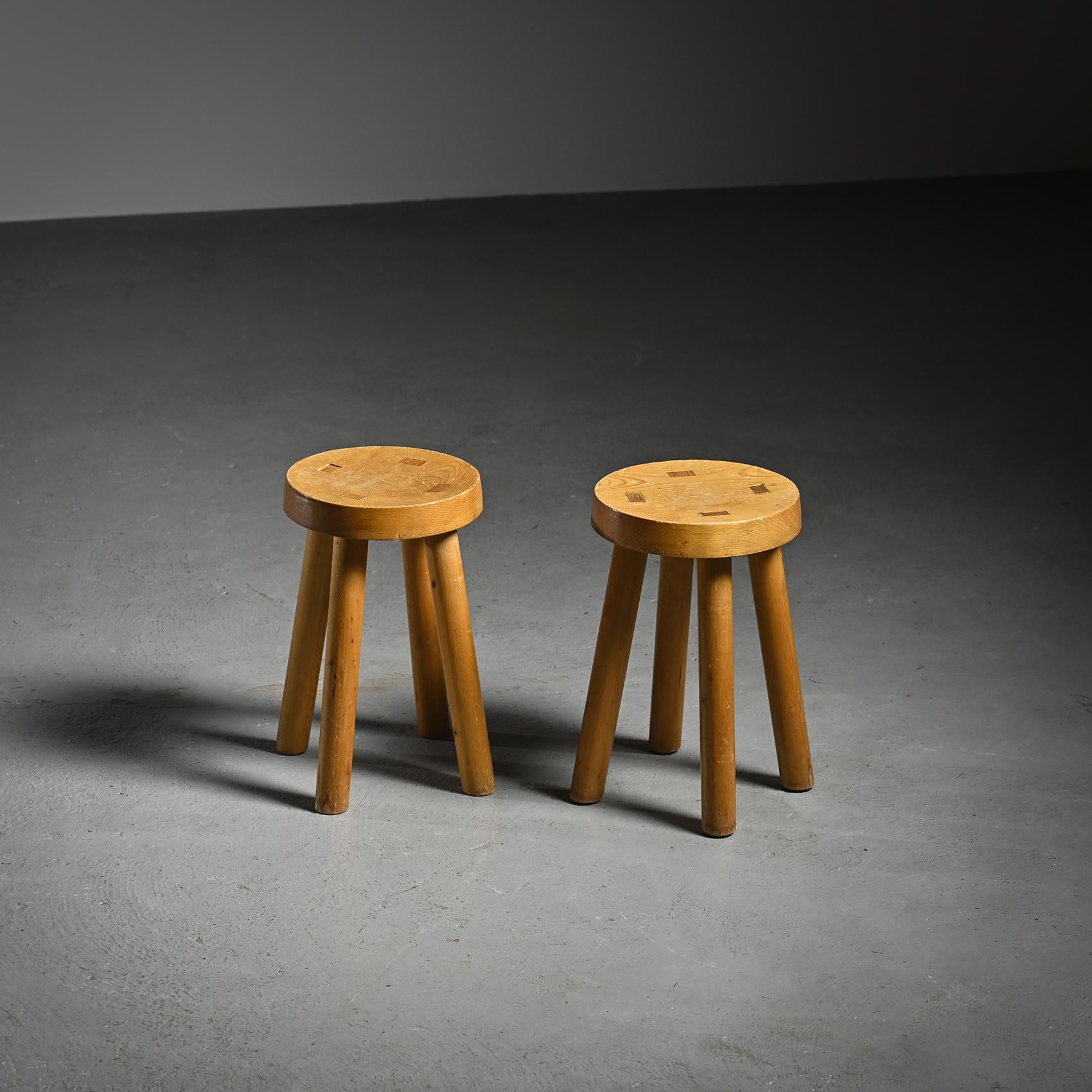  Pair of pine stools, made in the 1960s for the Les Arcs ski resort in the French Alps.

Each stool features a four-legged rounded structure supporting a slightly curved circular seat. The construction uses through-tenon joinery, adding a refined