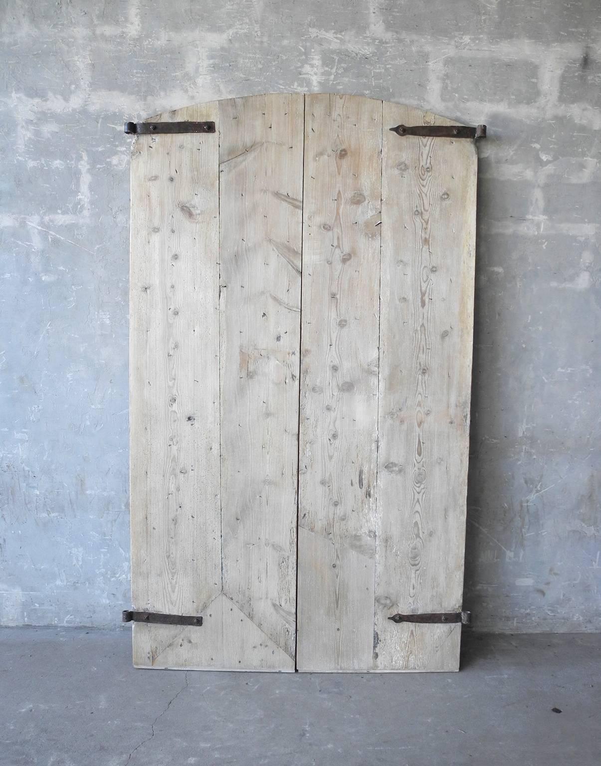 This is a fabulous pair of 18th century doors from a "Provençal Mas." They have been stripped to reveal they're beautiful natural wood. They also include antique hardware and nails giving the door a truly handmade feel. 