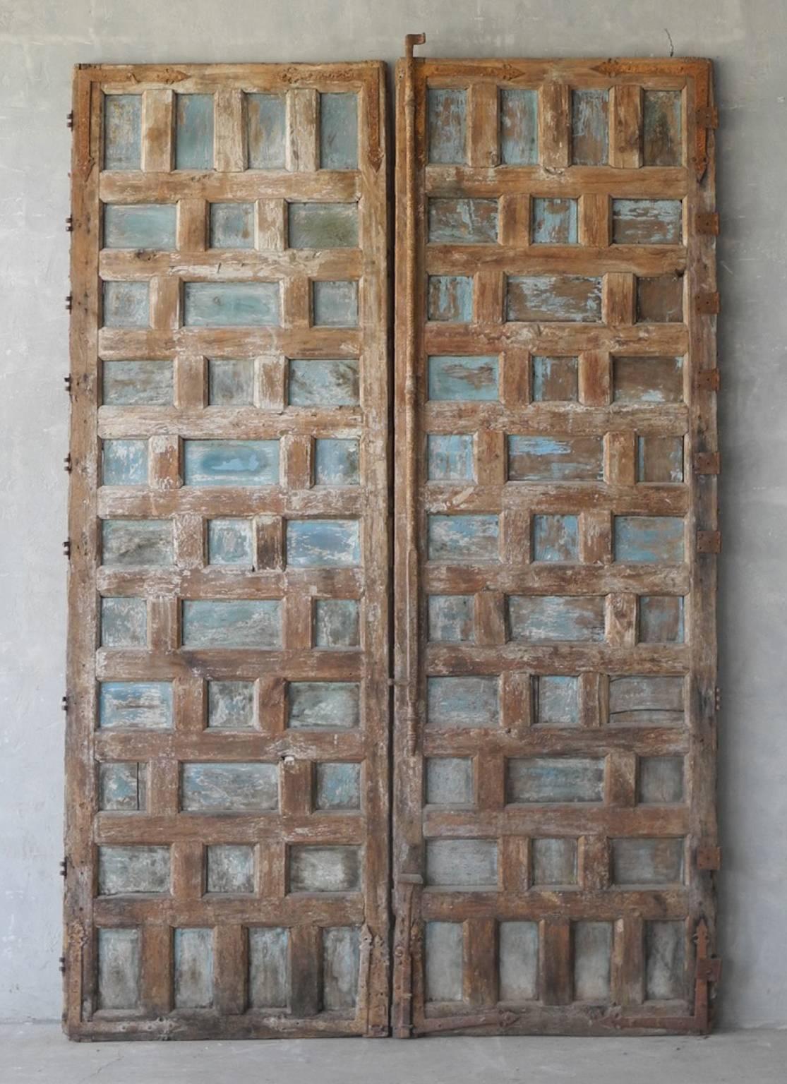 This pair of antique 17th century entrance doors from a "Palazzo" in Andalusia, Spain are grand in both height and detailing. It has carvings all over. It has been stripped, displaying its naturally antique wood. Hardware can be added. 
