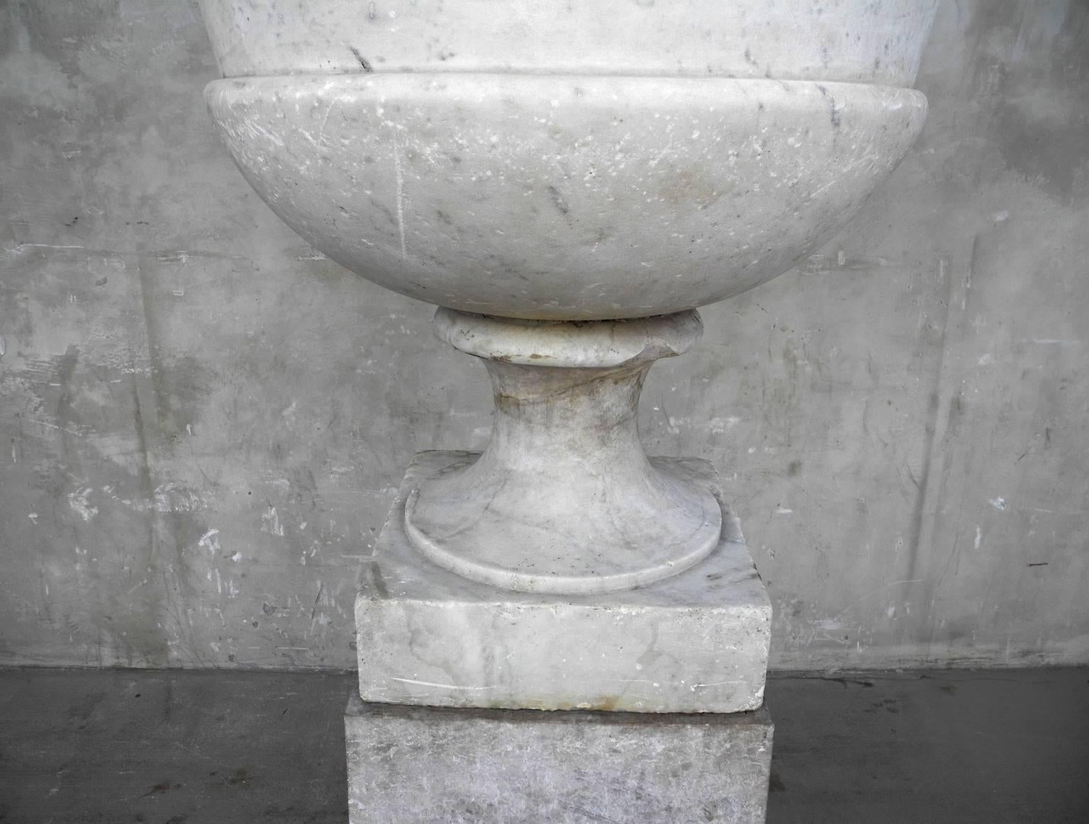 This antique 17th century marble urn and pedestal are from the courtyard of a villa on the Amalfi Coast. They stand very tall, so they are perfect for a centerpiece display. The urn can be filled with greenery. These items are very heavy, so they