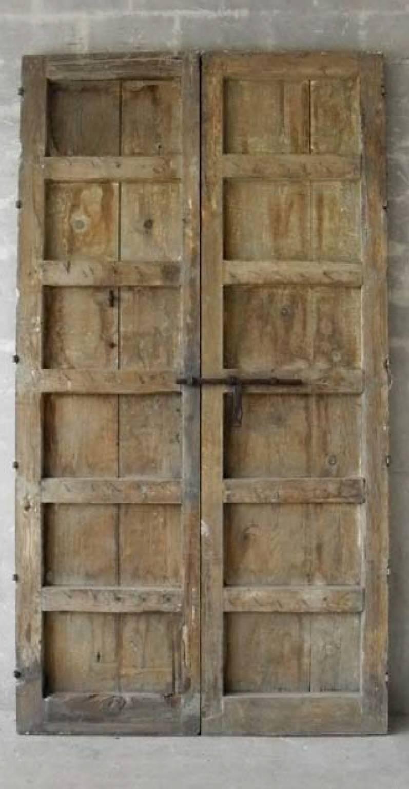 This is a grand pair of antique 18th century entrance doors from Andalusia, Spain. They stand very tall, perfect for any entrance. They also include original hardware - nails, enormous knocker, and hinges. They are made of natural wood, so they have
