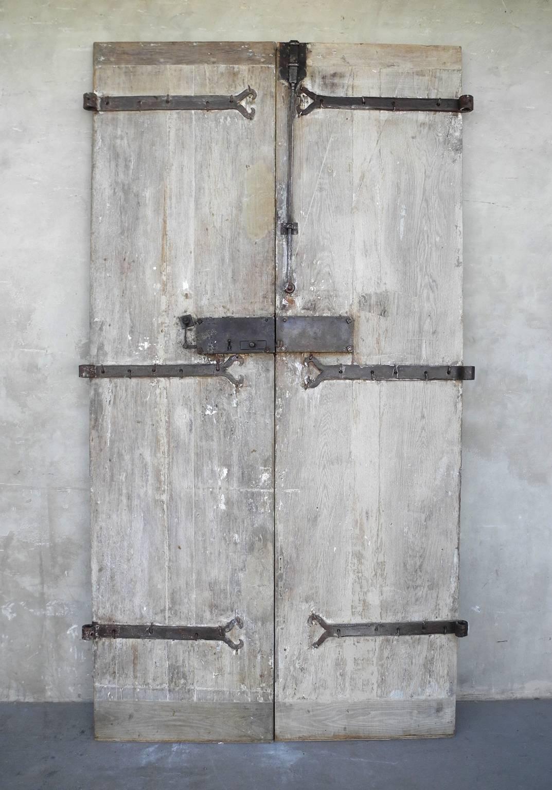 Pair of antique reclaimed 18th century entrance doors from a Bastide outside of Saint-Emilion, a Commune in Southwestern France.