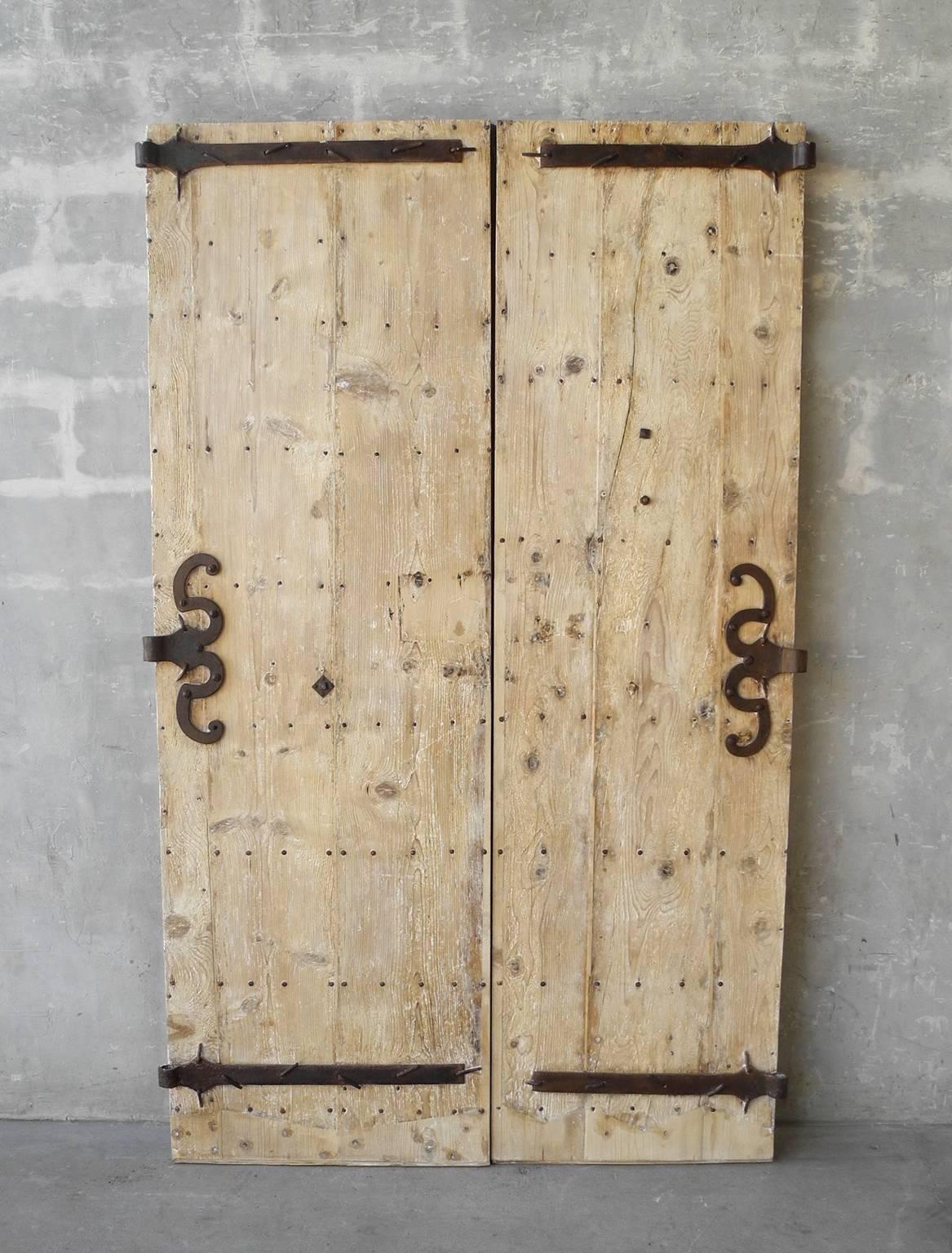 This is a simply beautiful pair of 18th century entrance doors from a property in St. Marcellin, a town in the Rhone-Alpes region of France. These doors include original hardware that has been refurbished, making for special iron detailing all