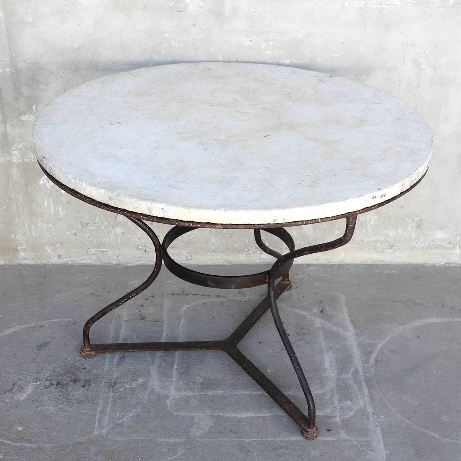 This antique French gueridon table, circa 1950, boasts a beautiful white marble top with strong iron base. It is in great condition, having minimal patina and aged marks. It is very sturdy and versatile. It is a medium sized table, so it can work as