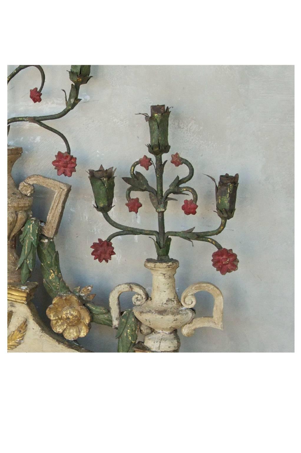 These 17th century sacristy elements from a chapel in Rome, Italy are a very special find. They are a matching pair with intricate carving and vibrant colors. They are a great size to display on any wall. They have gold detailing as well. 