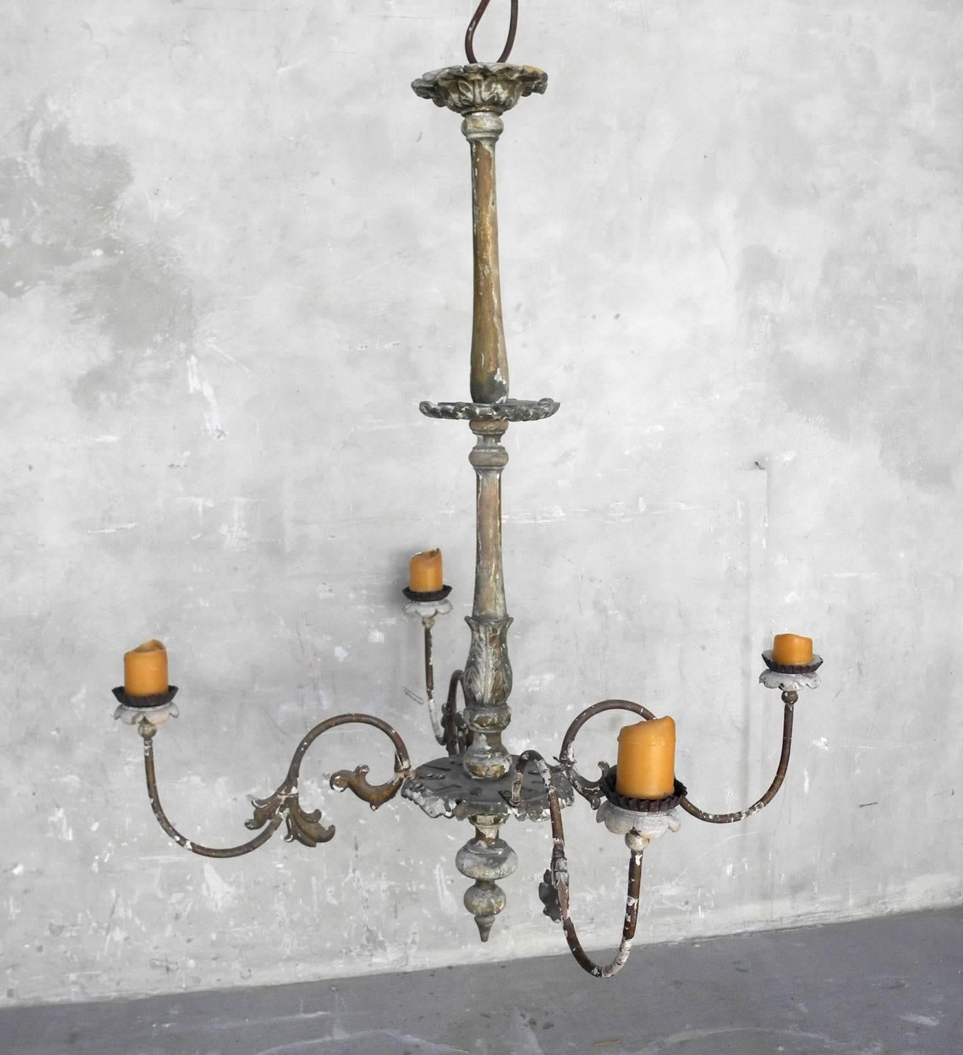 This 19th century French chandelier is large and simple. It has beautifully detailed arms that can hold four candles. It has a very long middle making it a great size for above a dining room table. It can be electrified if desired.  