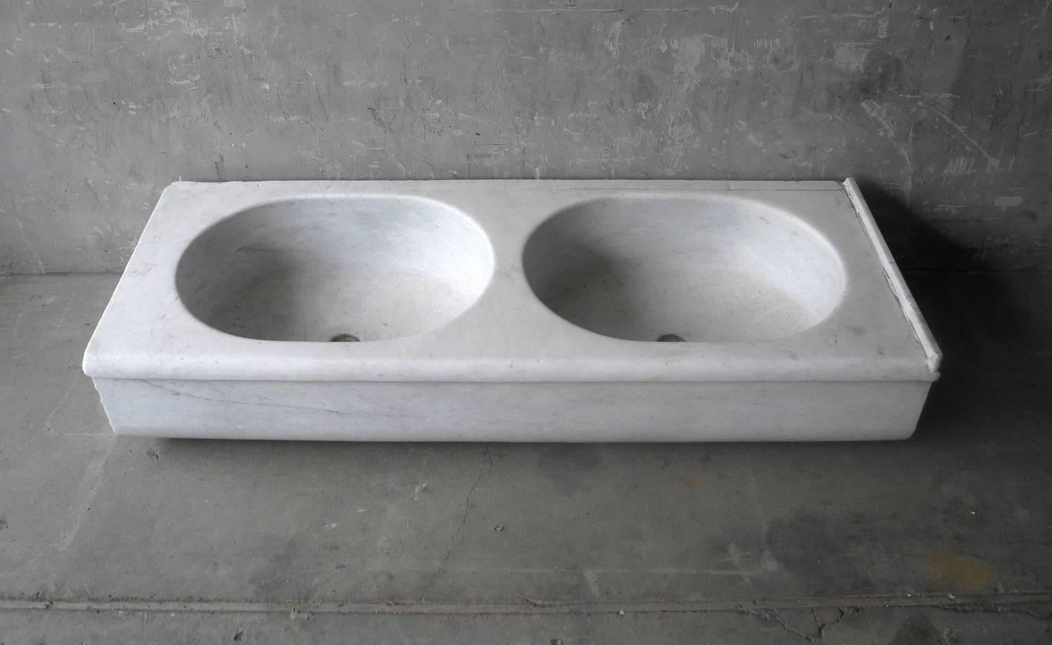 This is a very large white marble 19th century double sink from a villa outside of Arezzo, Italy. Due to it's enormous size, this antique is a very special piece. It is the perfect center to any master bathroom.