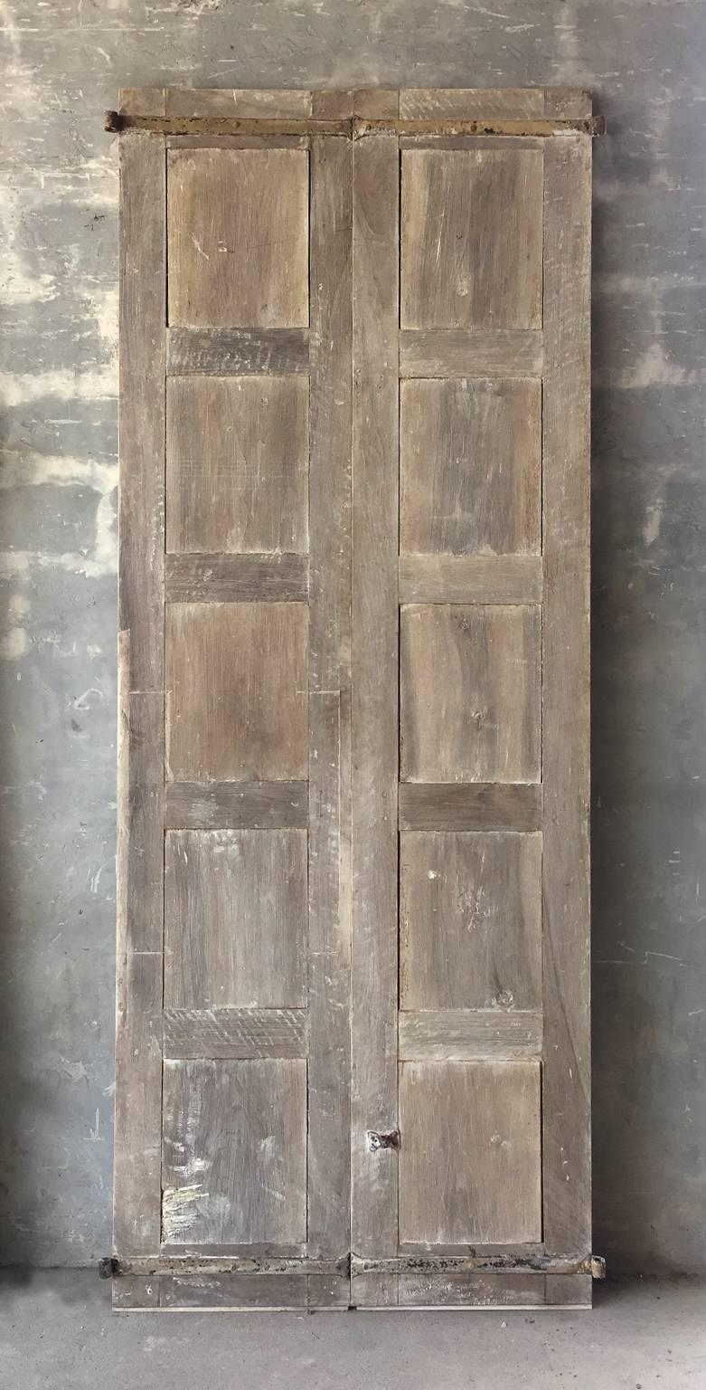 This is a very tall and lovely pair of antique 18th century walnut doors from Umbria. They include original reclaimed hardware, paneling, and natural finish.