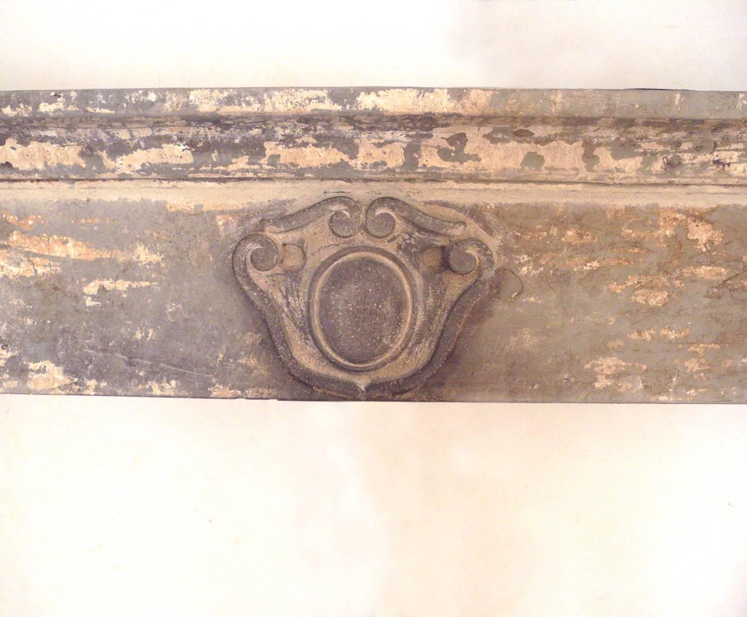 This is an antique, 17th century mantel from an important property near Gubbio, a town in the Umbrian region of Italy. It has carved legs and lintel and includes a beautiful crest in the center. It is a relatively good size and has interesting