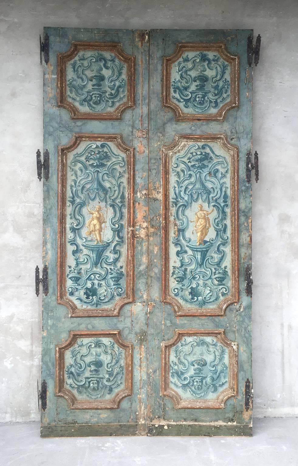 This is a tremendous pair of extravagantly painted antique doors. From 18th century Naples, these doors boasts their original paintings on both sides. They also include original hardware.