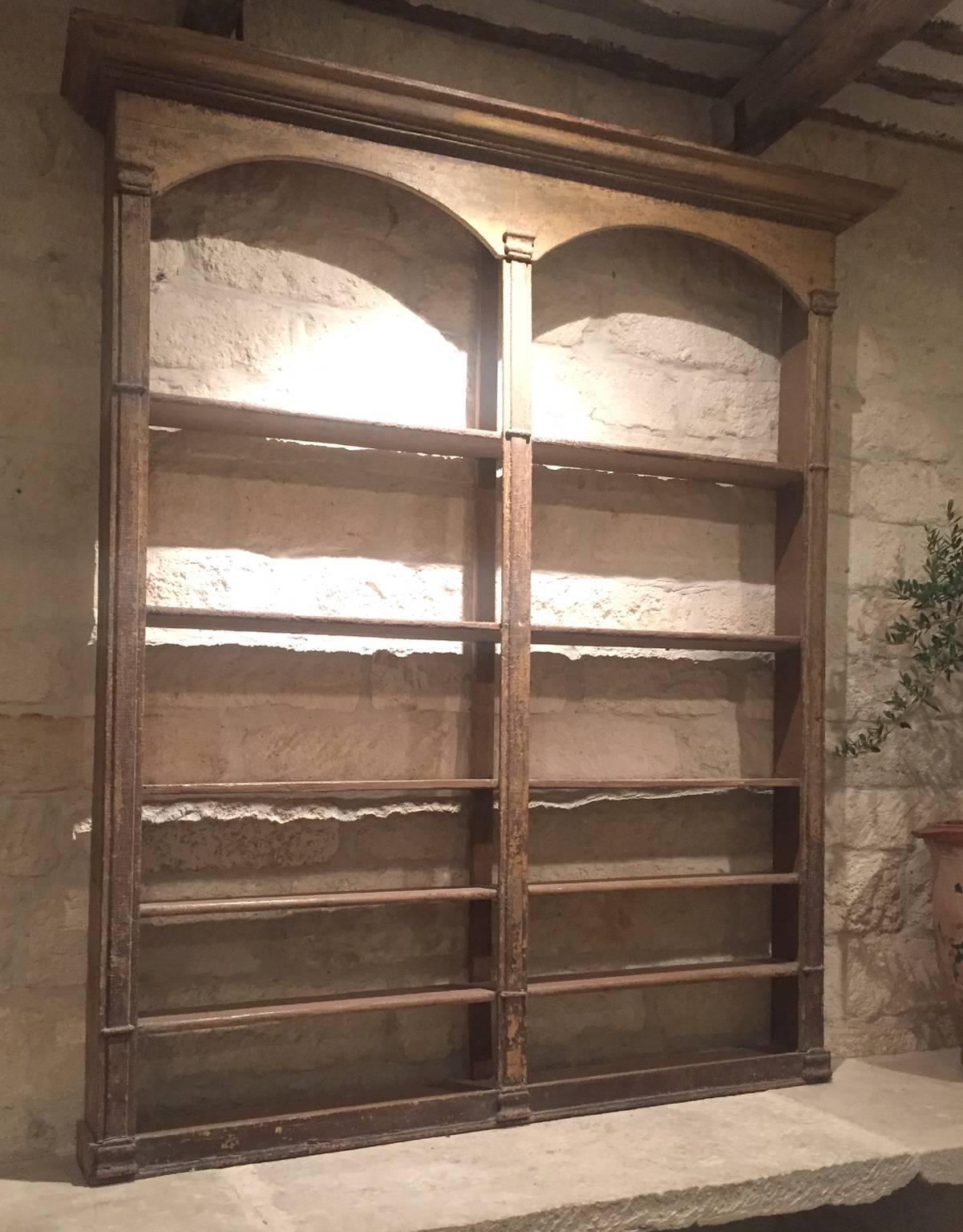 This is an adorable bistro shelf from 19th century, France. It fits to be placed atop a counter or table. It includes original wood and patina, several shelved for storage and beautiful arched tops.