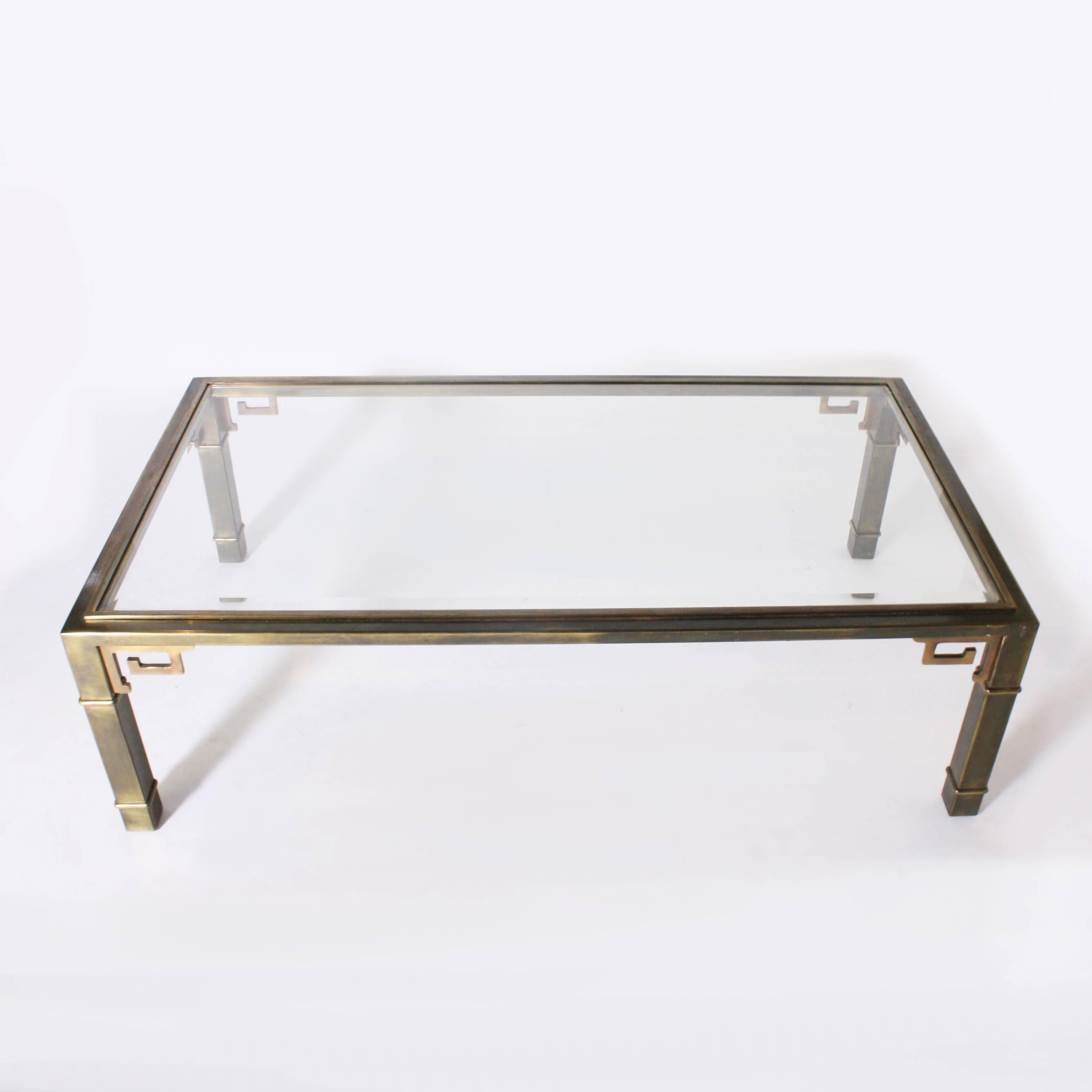 1970s rectangle Mastercraft coffee table with Greek key detail. This coffee table has a clear glass top.
 