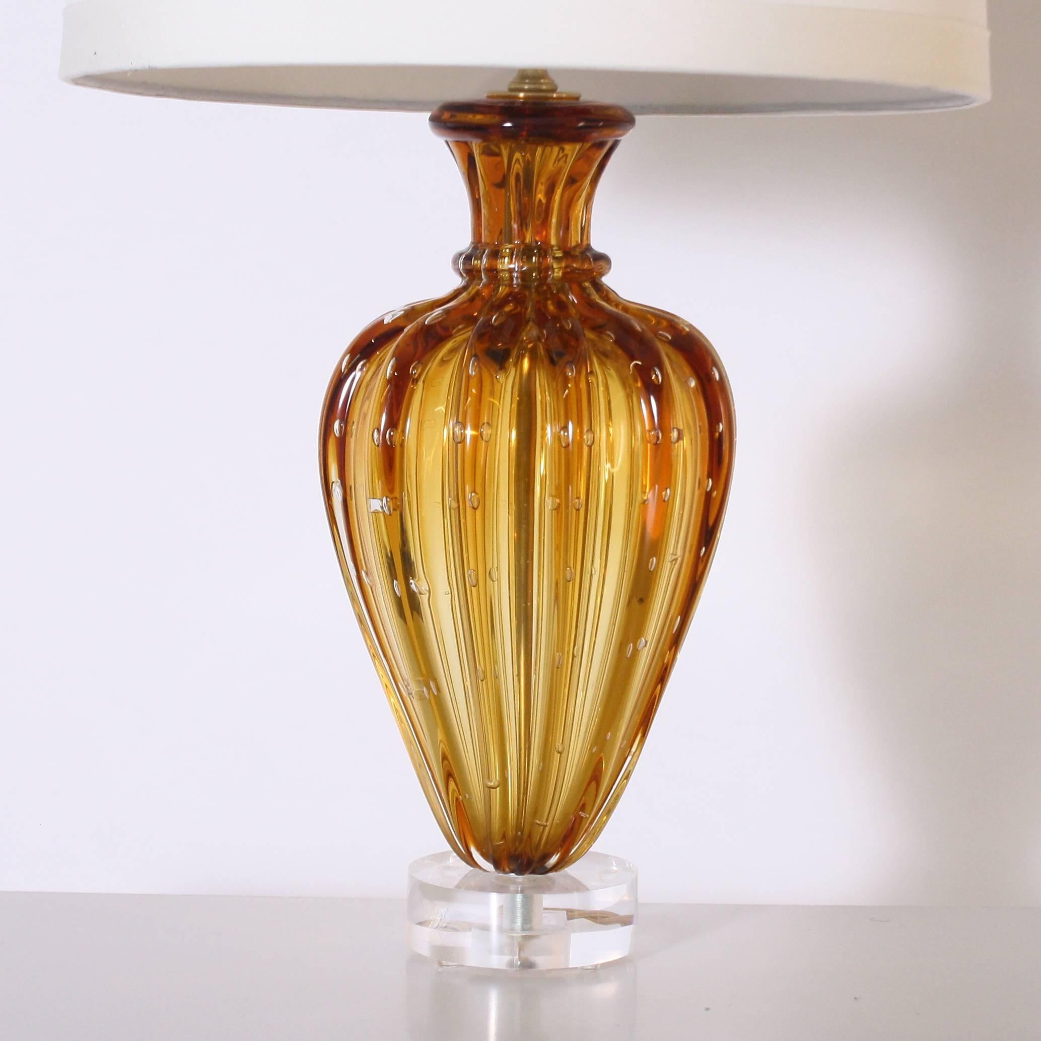 Small amber Murano glass lamp with clear bubble inclusions, circa 1960.
       