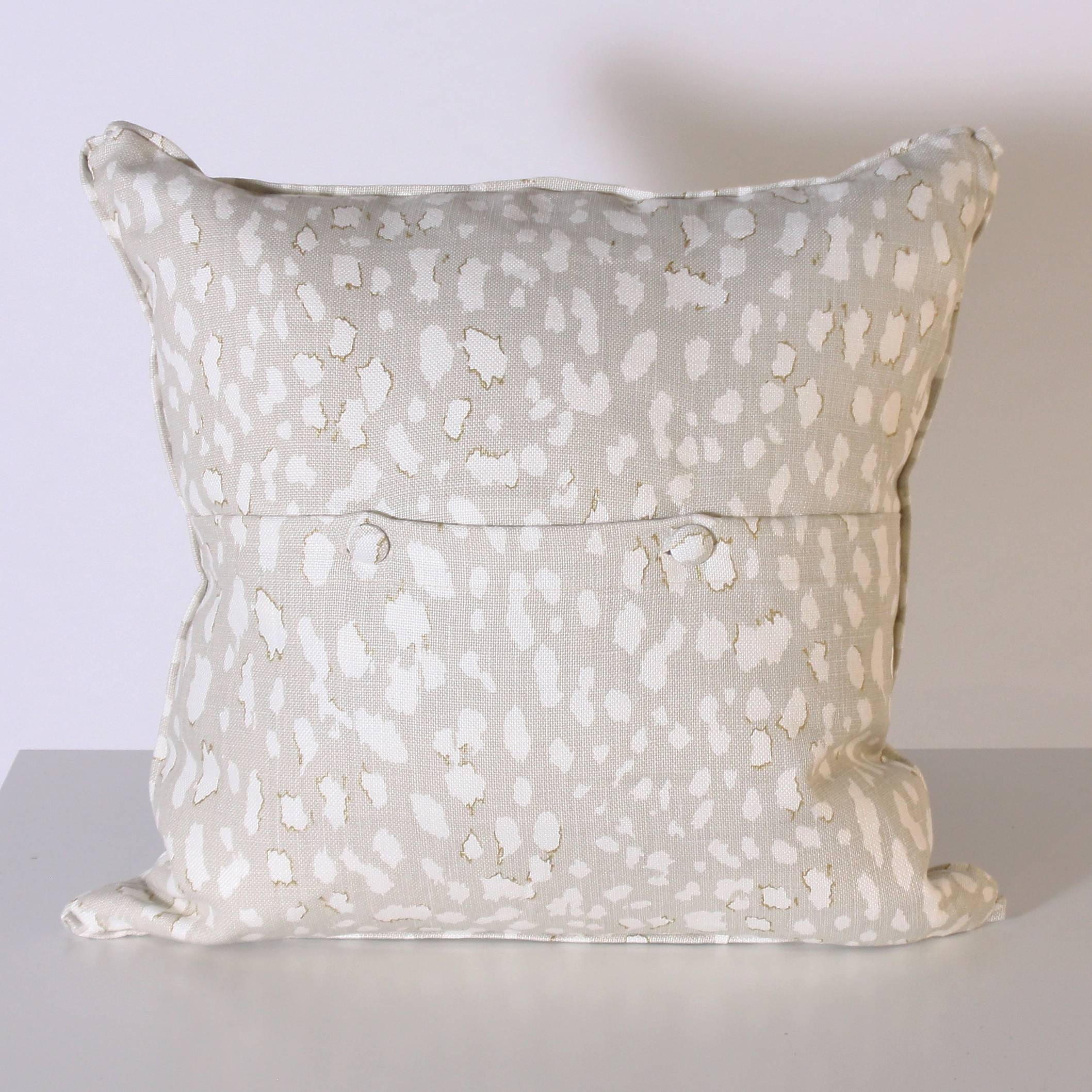 Pair of pillows upholstered in Jan Showers for Kravet Lynx Dot Oyster fabric

