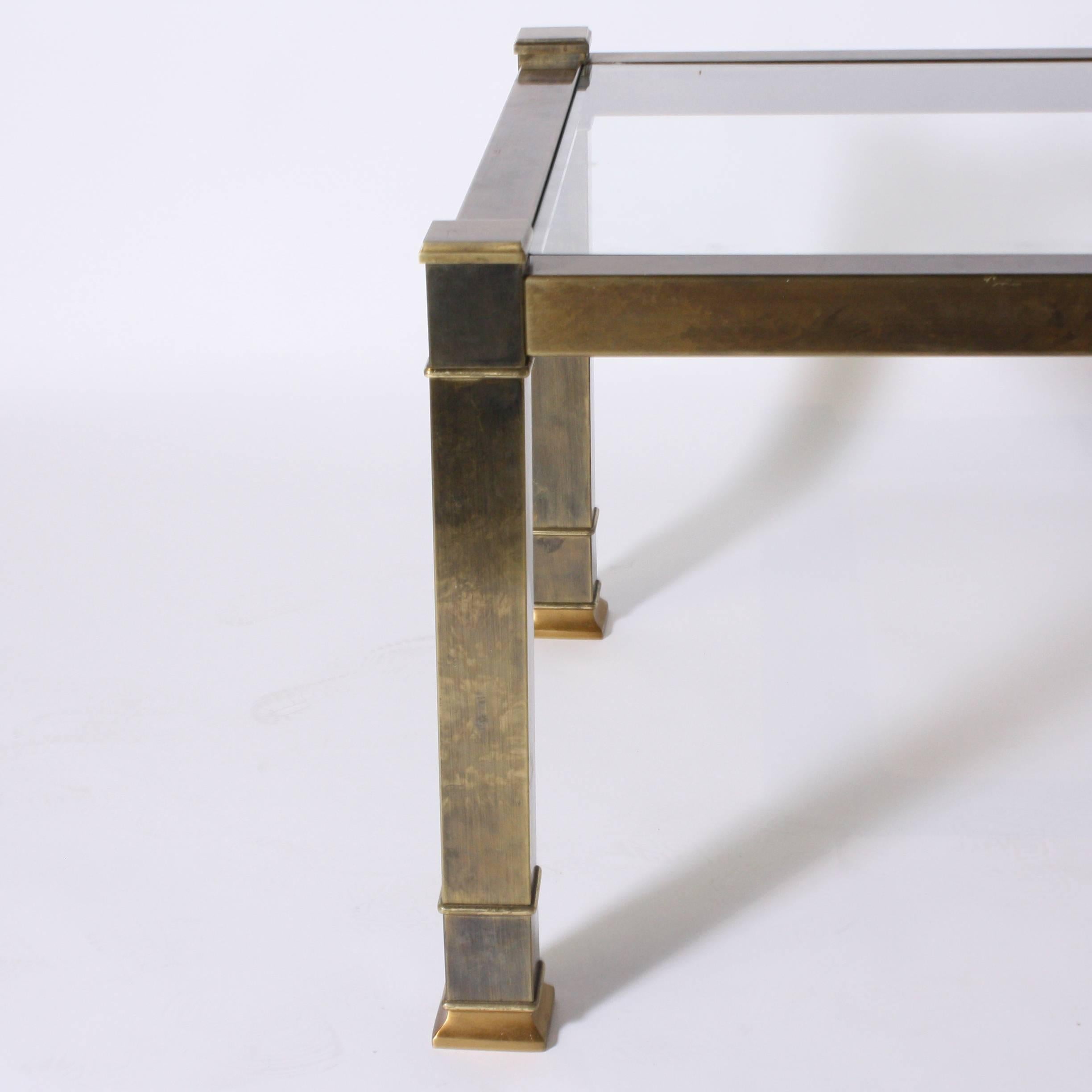 Pair of brass mastercraft side tables with glass tops.