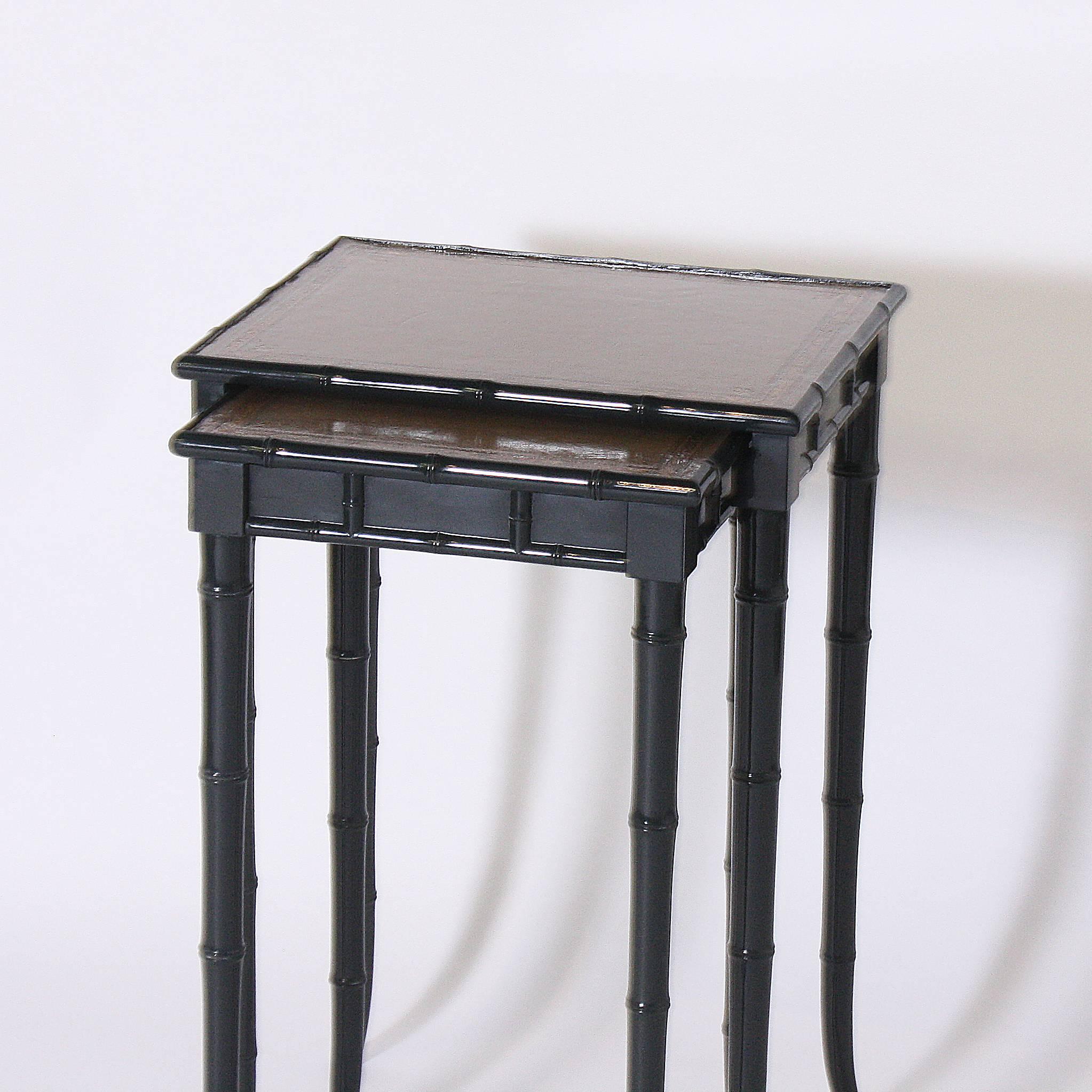 This set of faux bamboo nesting tables have been re painted in Benjamin Moore, black forest green. The leather tops are original and have been lacquered to prevent any further antiquing.

Measures: Large table: 17