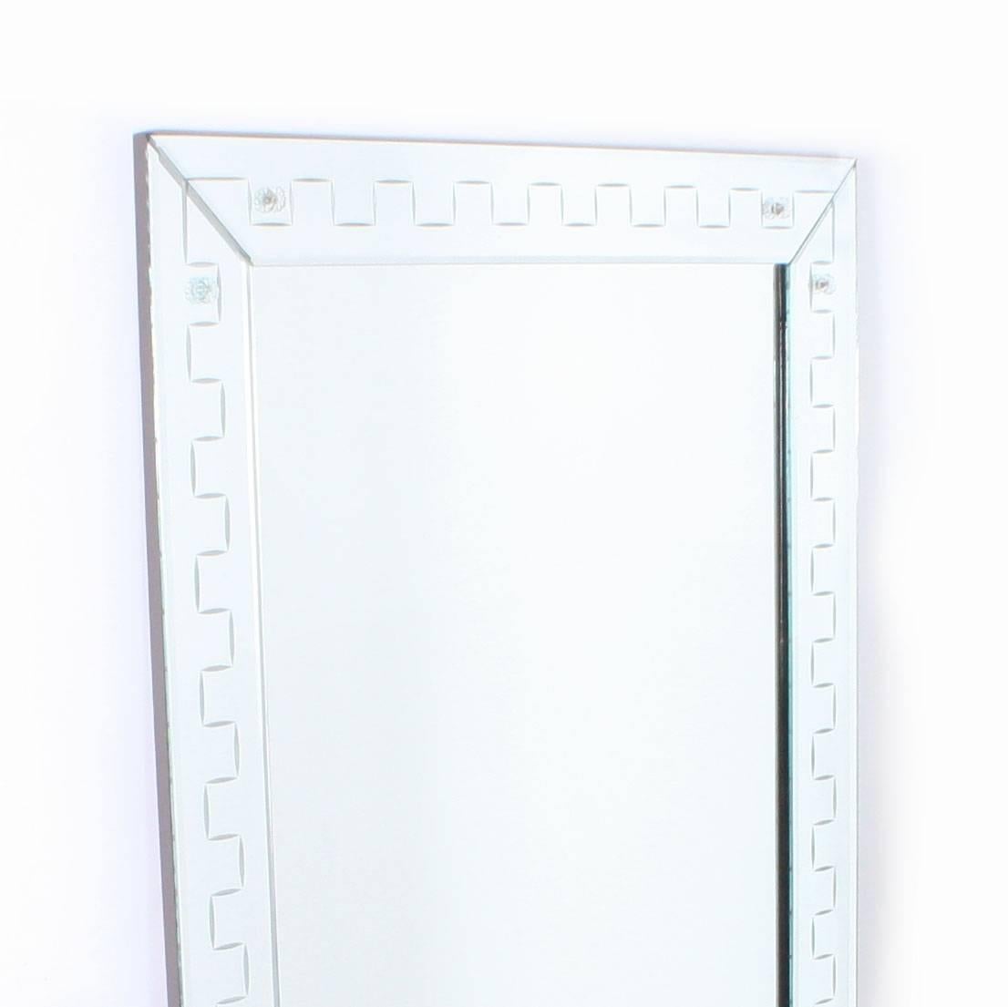 This French clear mirror frame mirror has glass rosettes and Greek key detail along the frame.