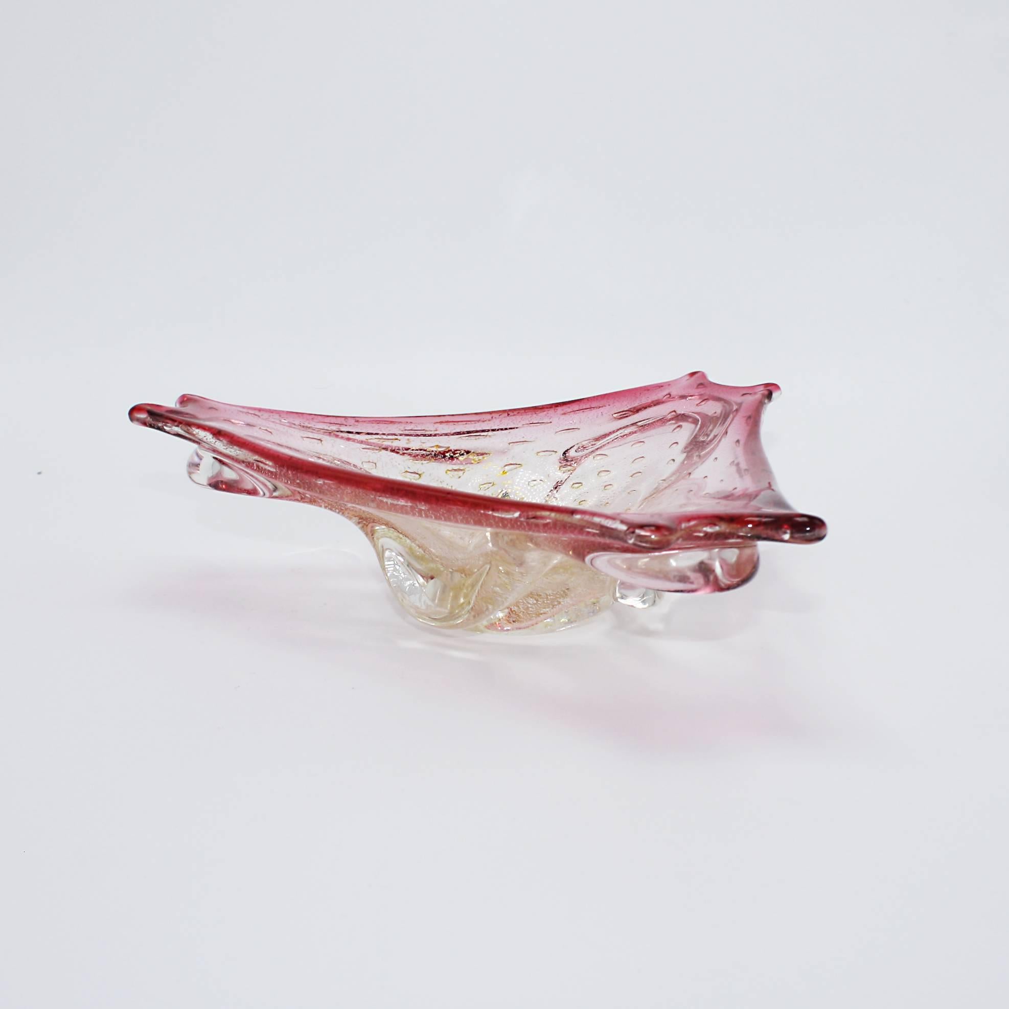 Dark pink and gold Murano glass bowl with bubble inclusions and gold flecks, circa 1960.
  