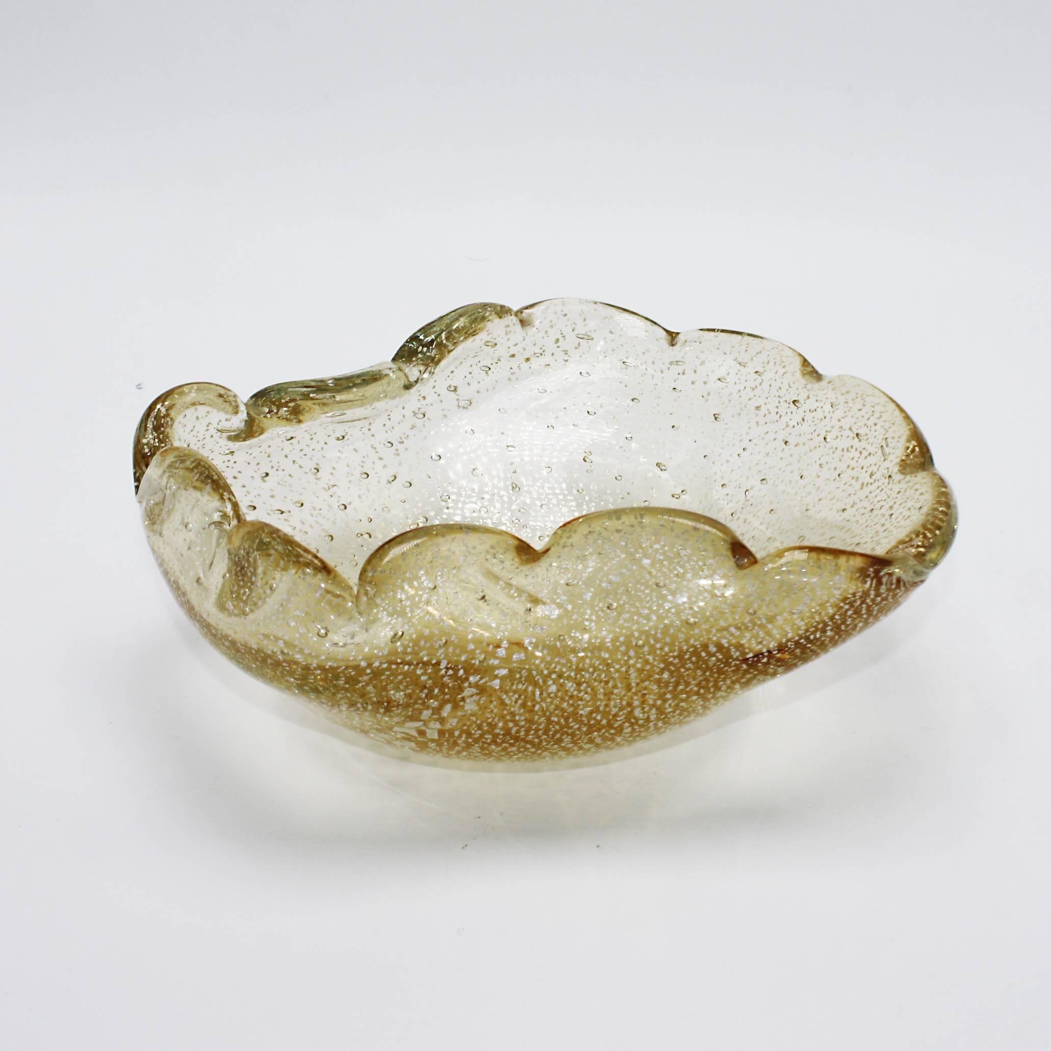 Gold Murano glass bowl with clear bubble inclusions and gold flecks, circa 1960.
   