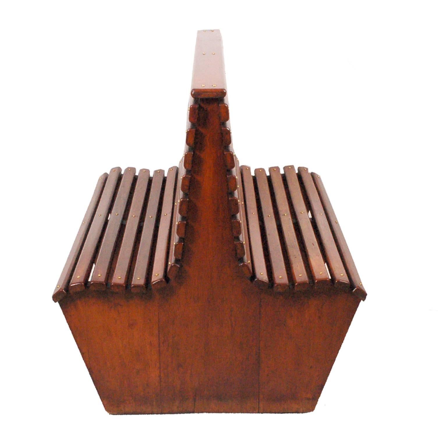 Unusual two-sided solid mahogany slat bench with brass screw connection. Can be used in a garden or covered patio area.