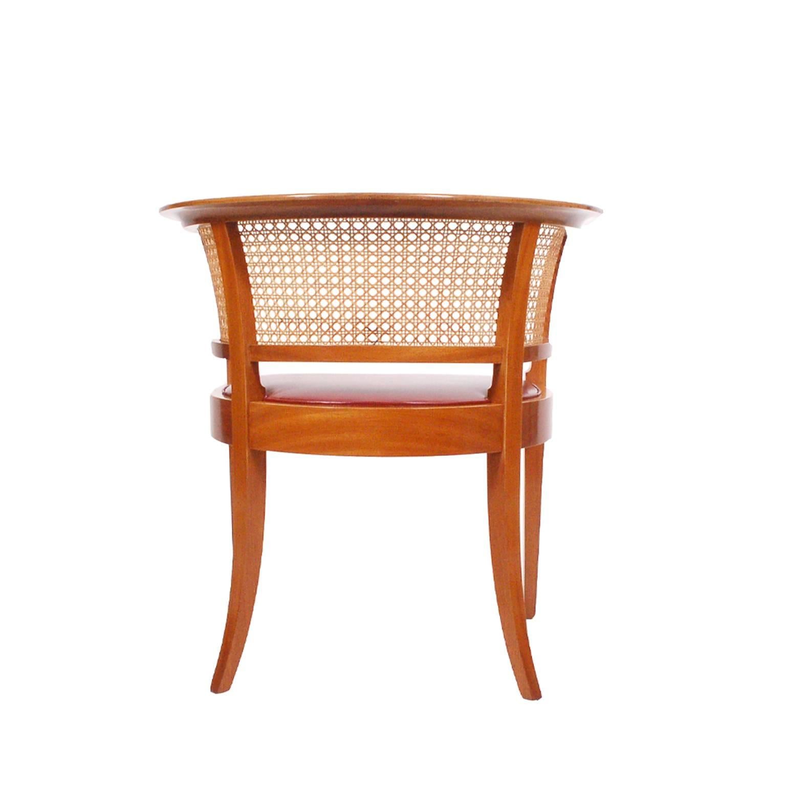 Originally designed in 1914 and in production since 1931. This is from the second half of the 20th century. Solid mahogany, cane back and leather seat. 
Made by Rud Rasmussen.