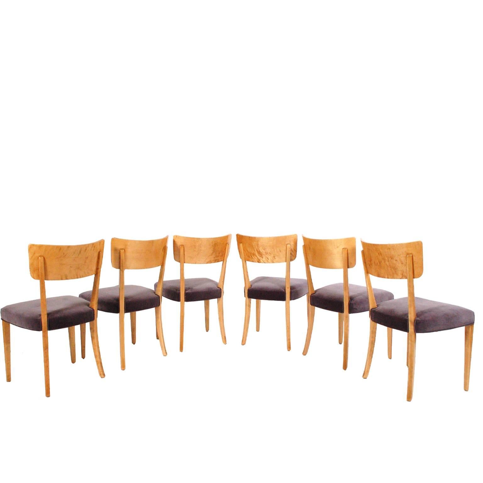 Six dining chairs with curved back; solid birch frames, backrest of ashwood with bird's-eye maple band. Fluted design to legs. Upholstered in new grey velour.