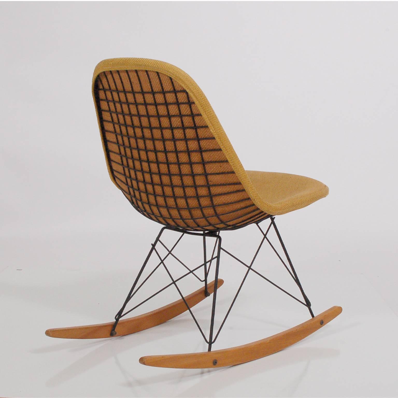All original, early rocker, black wire frame with birch struts, original fabric upholstered cover. This rocker has been on the carpet all its life. Paper tag is retained, with Herman Miller Furniture Co., Venice CA. Beautiful museum condition.