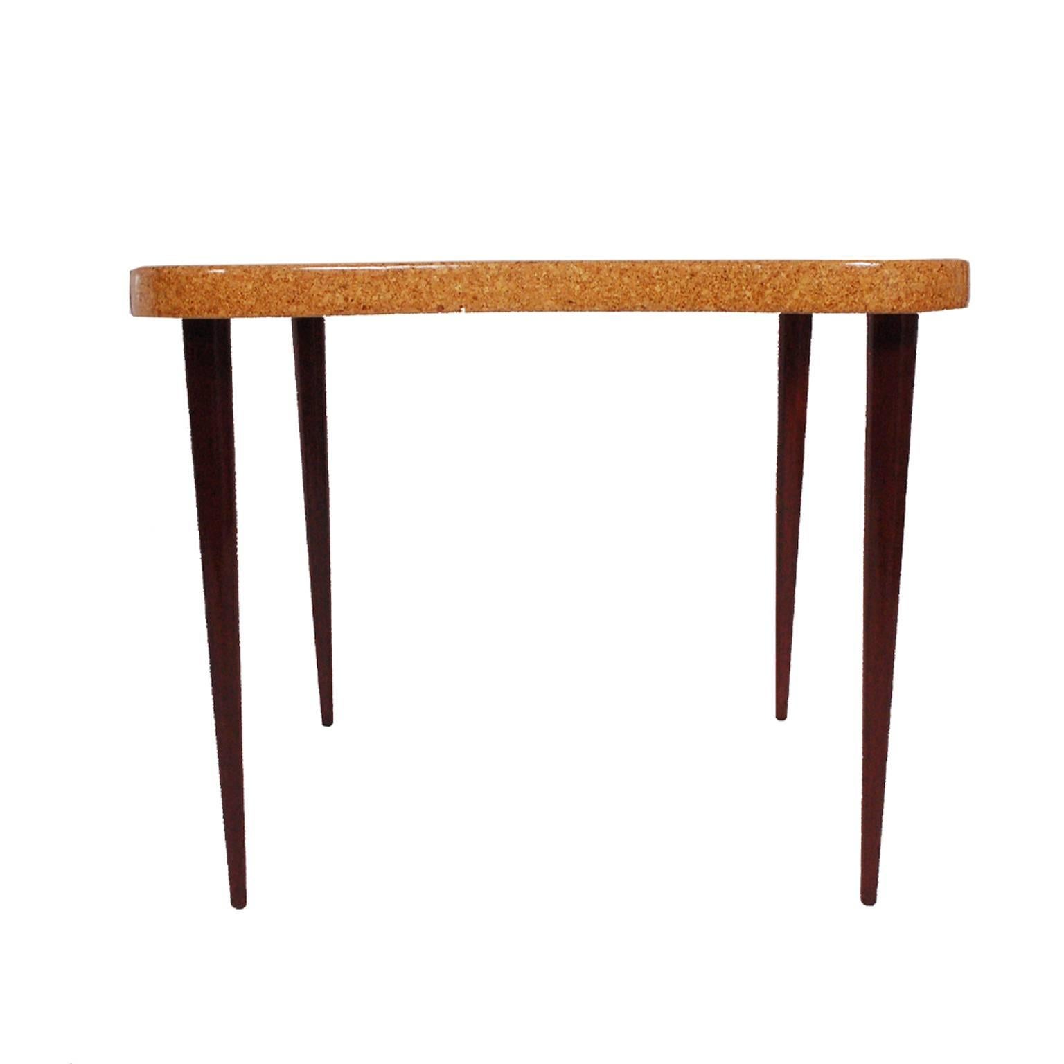 Free-form cork top game table on four tapered solid mahogany legs. 
Made for Johnson Furniture Co.