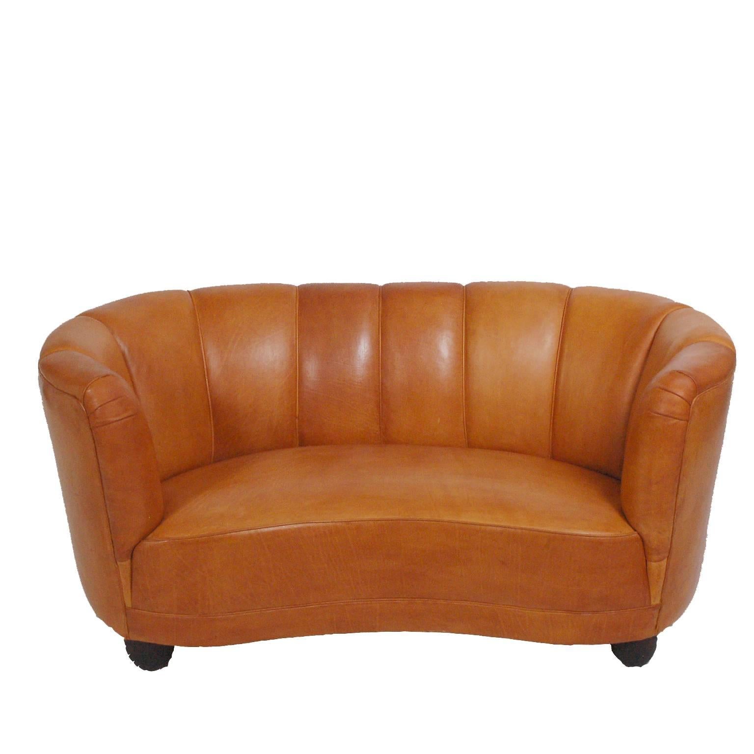 Free-form two-seat sofa and easy chair newly upholstered in natural leather. Design attributed to Flemming Lassen.
Chair size 35 D" W x 33" D x 27" H x 15" SH.
Can be sold separately.