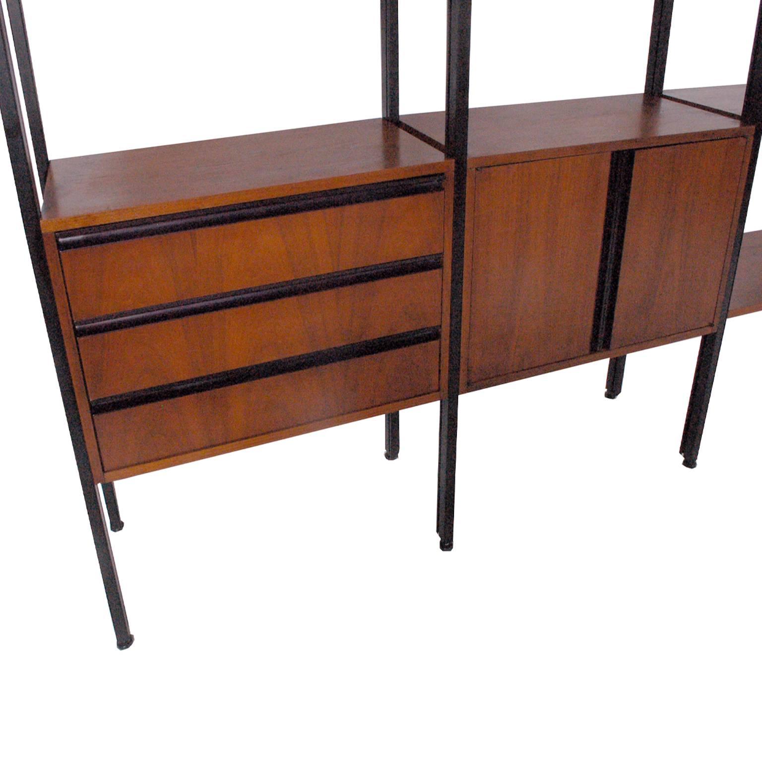 Eight pole room divider, walnut with extruded aluminum poles, anodized black finish. Three-drawer chest and two door section. Adjustable shelves. Designed by William Katavolos, Robert Gargiule, associates at George Nelson's office. Documented at