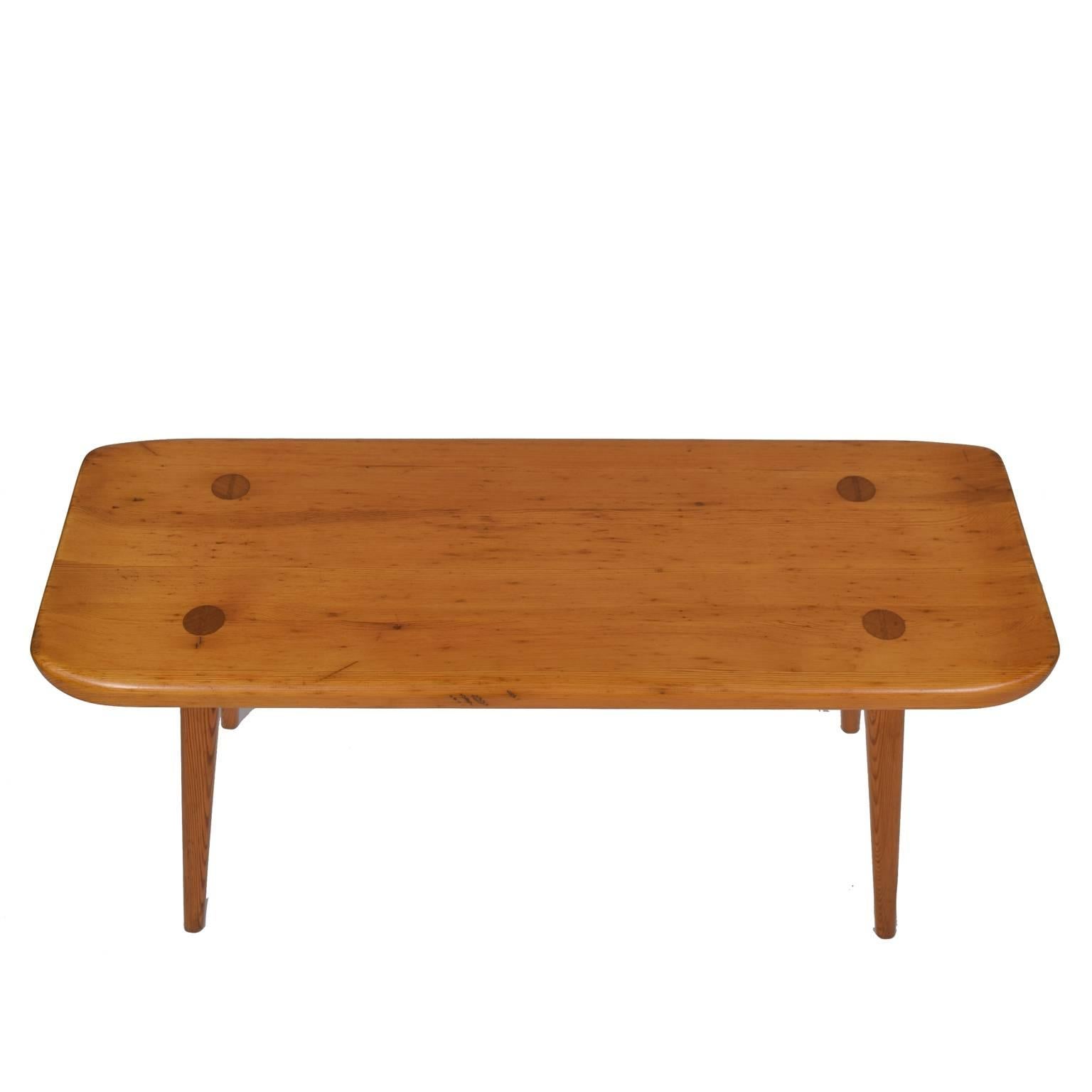Small bench with curved ends and four legs. Produced by Svensk Fur in Sweden.