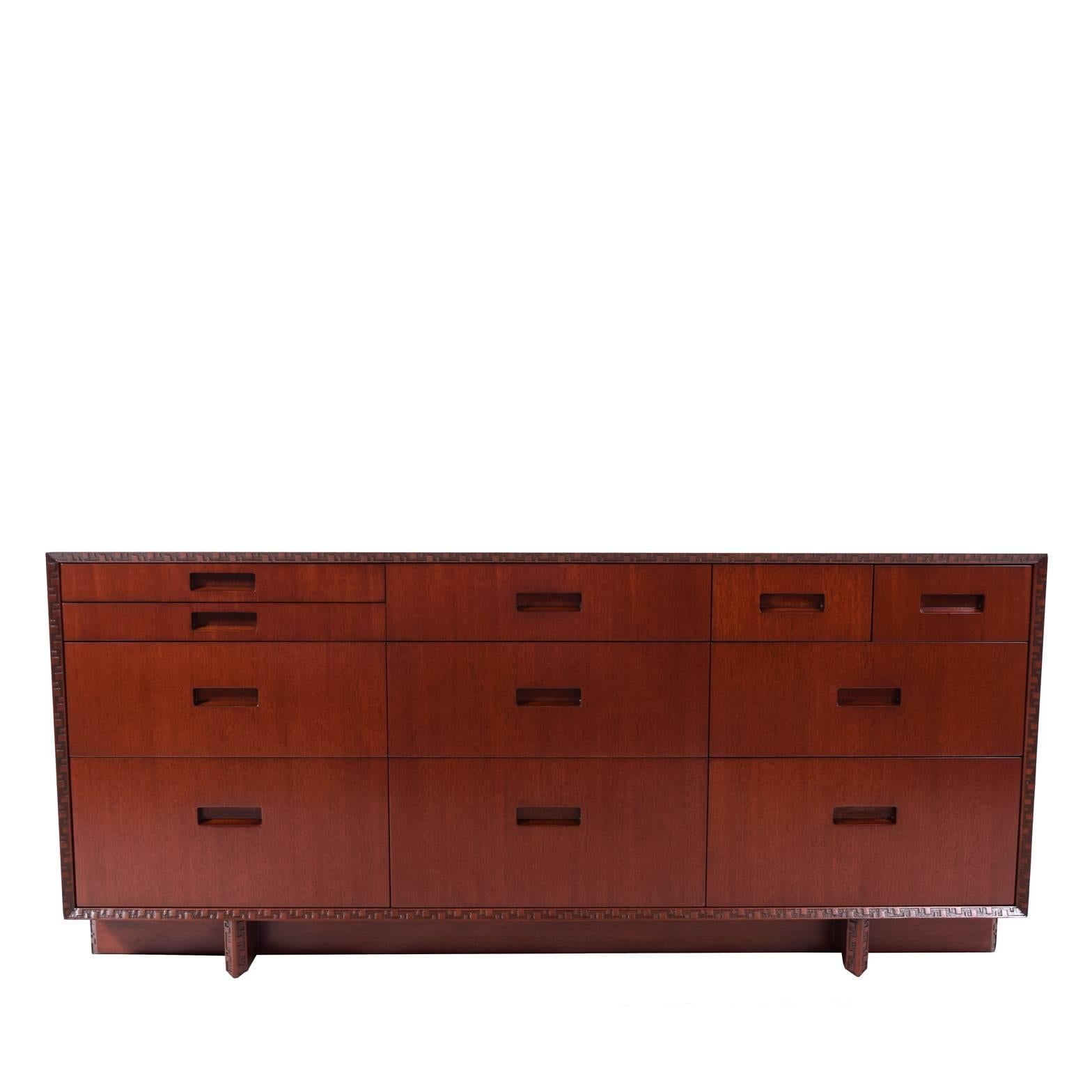 Mahogany chest with 11 drawers of varying sizes and removable shelf to top.
Taliesin design on edges. Crossed plank base.
Marked on back. Made by Heritage Henredon.
Measurements below without shelf.