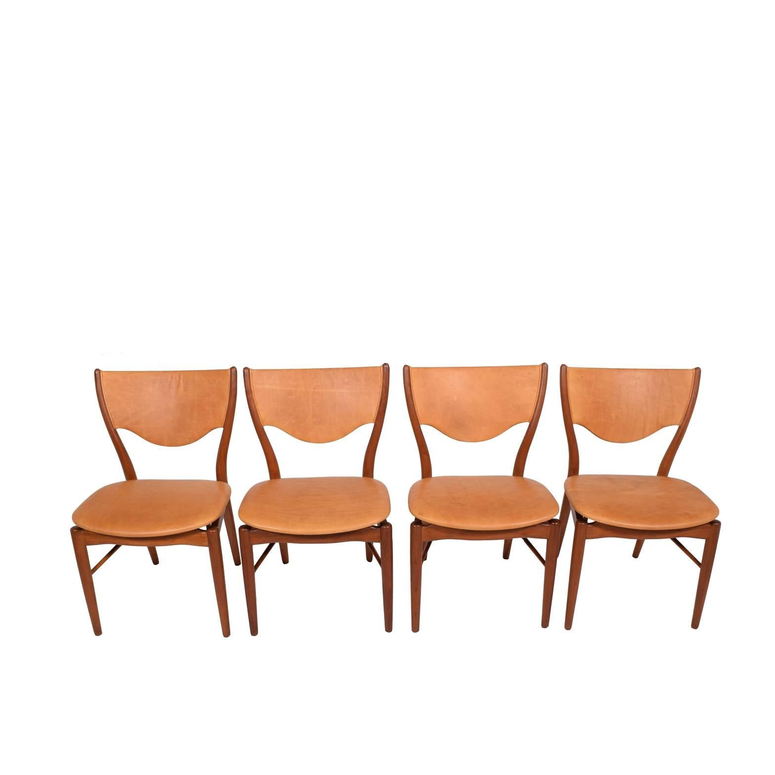 Four solid teak frame and patinated natural leather upholstered side chairs. Designed in 1952 for Bovirke, Denmark. Ink stamp to lower stretcher.